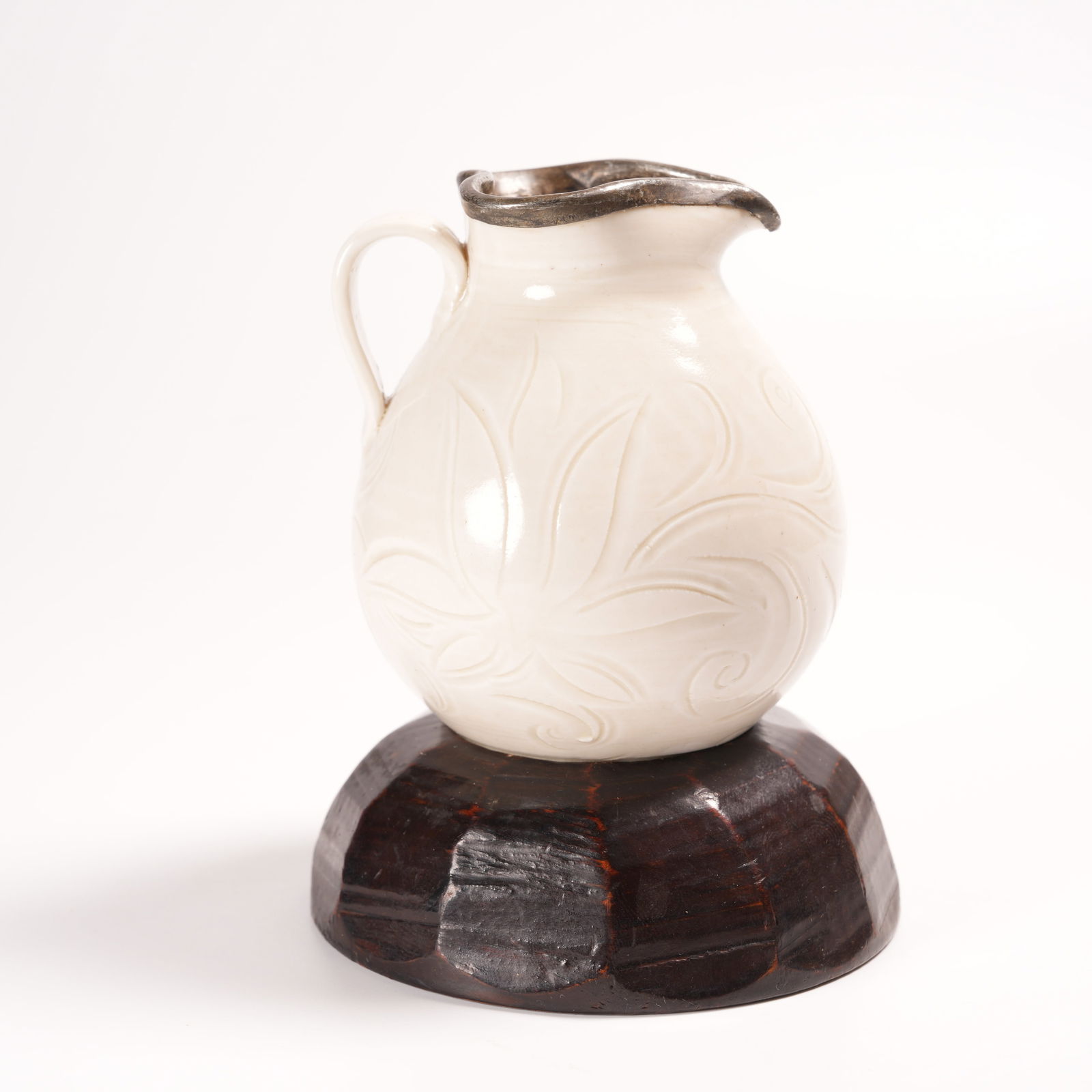 A DING KILN FLOWER-PATTERNED SPOUTED VASE: Ding Kiln Flower-Patterned Spouted Vase
