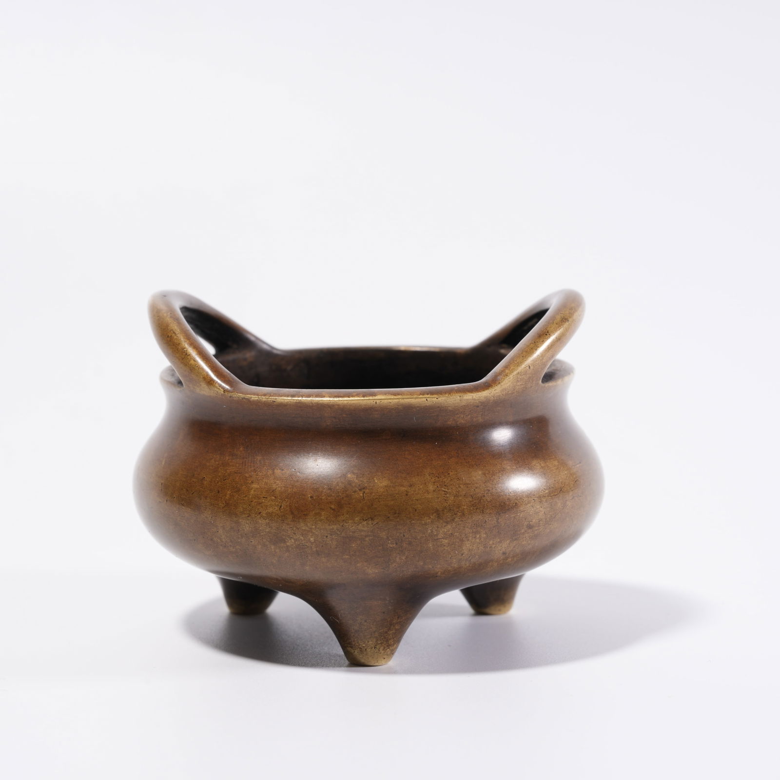 A BRONZE DOUBLE-HANDLED TRIPOD INCENSE BURNER: Bronze Double-Handled Tripod Incense Burner