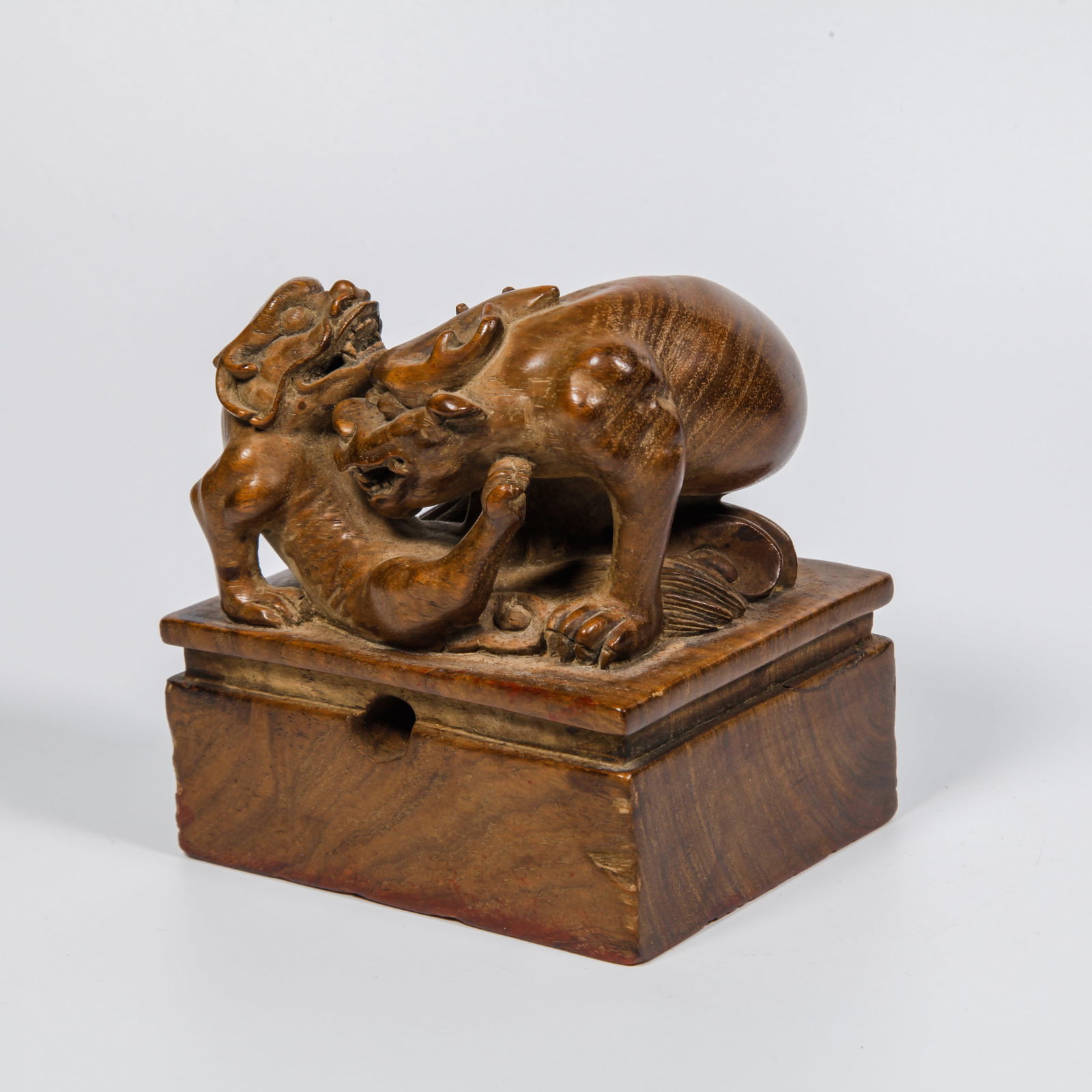 A HUANGHUALI WOOD CARVED AUSPICIOUS BEAST-HEAD SEAL: Huanghuali Wood Carved Auspicious Beast-Head Seal