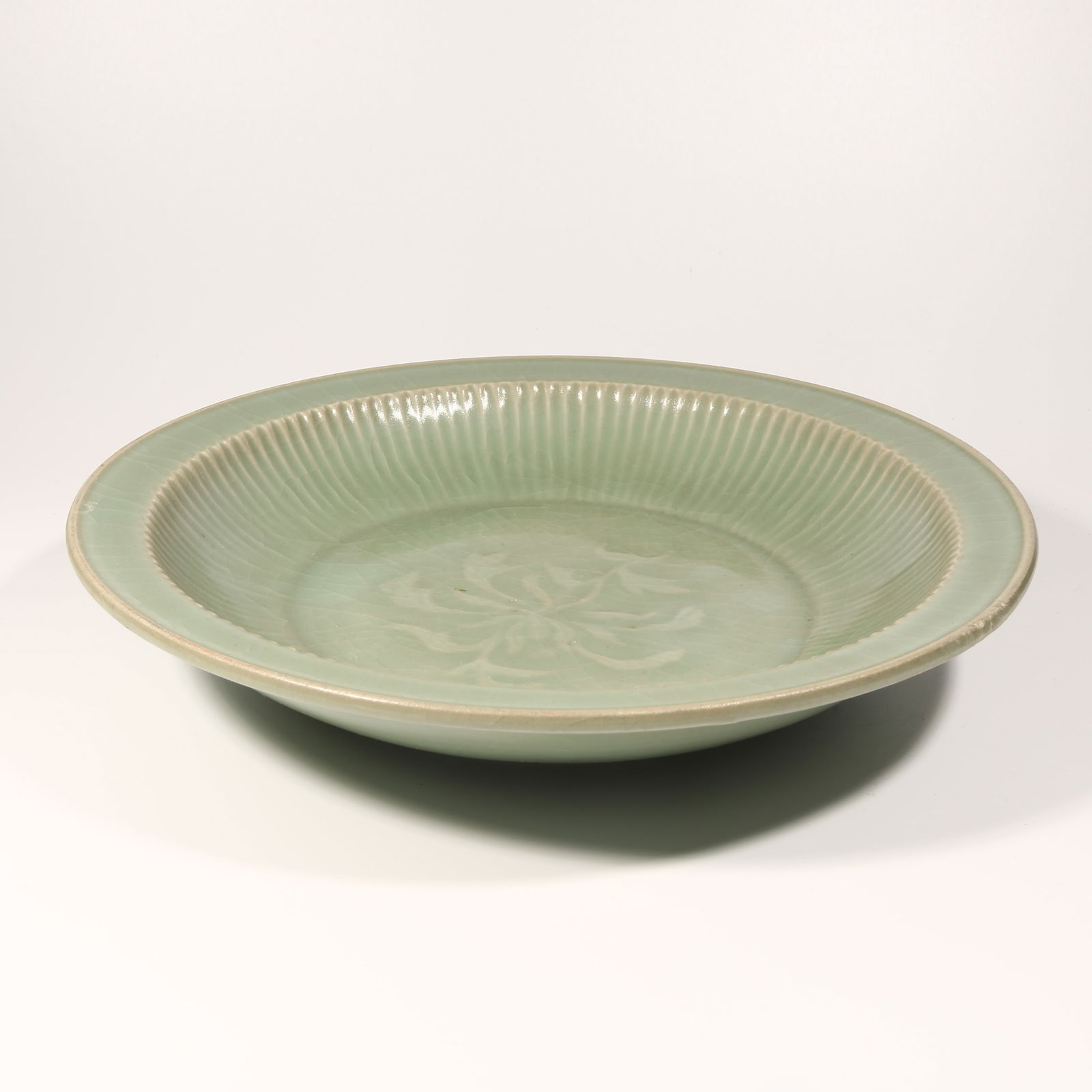 A LONGQUAN KILN FOLDED-RIM PLATE: Longquan Kiln Folded-Rim Plate