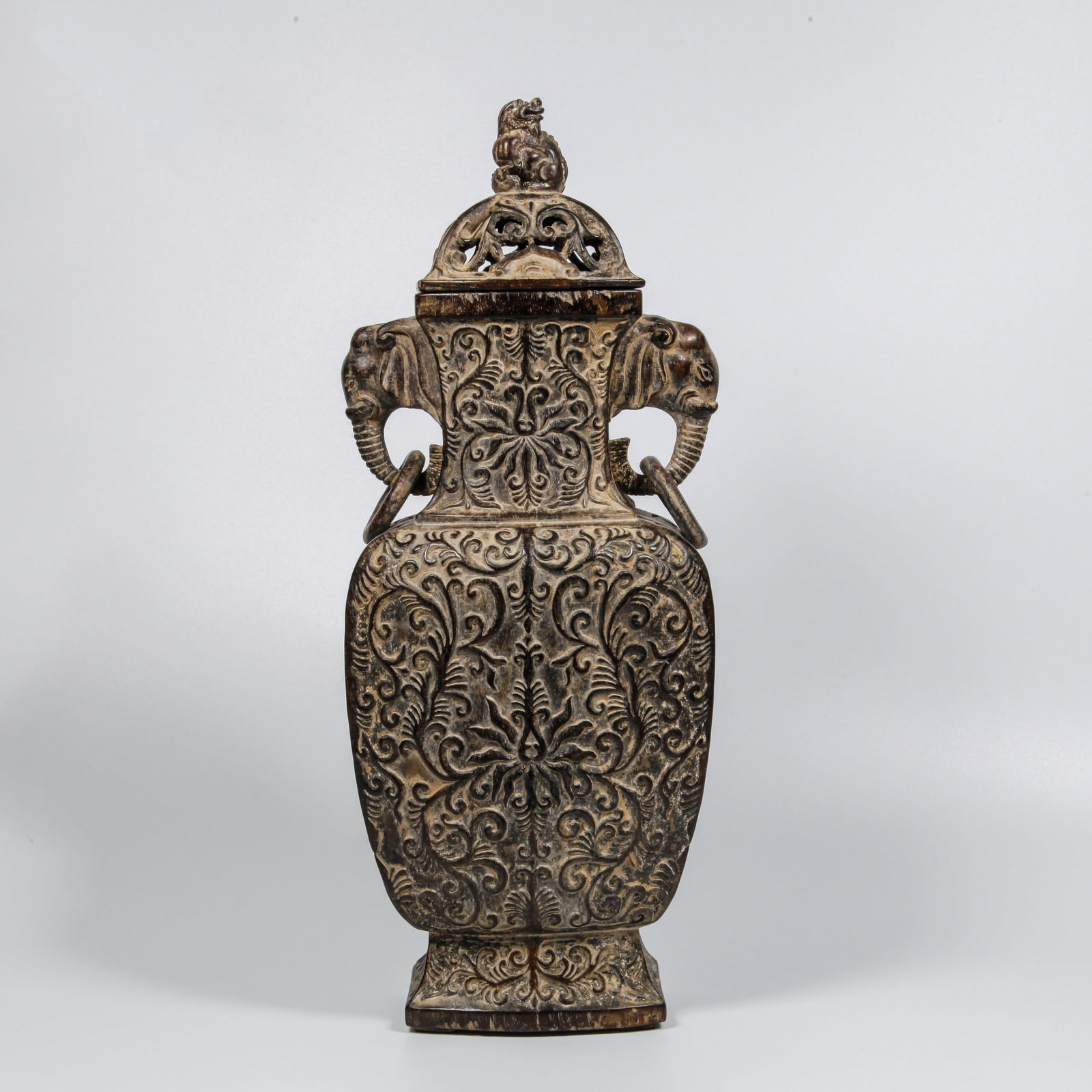 A ZITAN WOOD CARVED INTERTWINED FLOWER PATTERN DOUBLE-ELEPHANT-HANDLED COVERED BOTTLE: Zitan Wood Carved Intertwined Flower Pattern Double-Elephant-Handled Covered Bottle