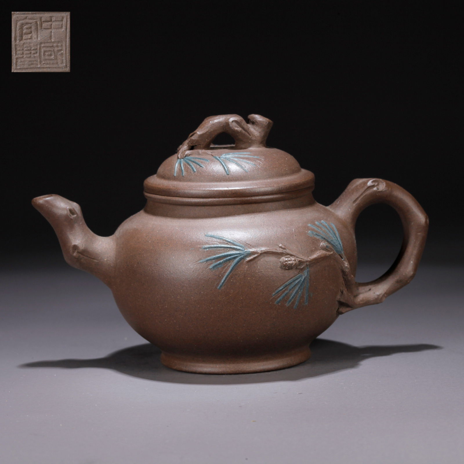 A PURPLE CLAY (ZISHA) FLORAL-PATTERNED TEAPOT: Purple Clay (Zisha) Floral-Patterned Teapot