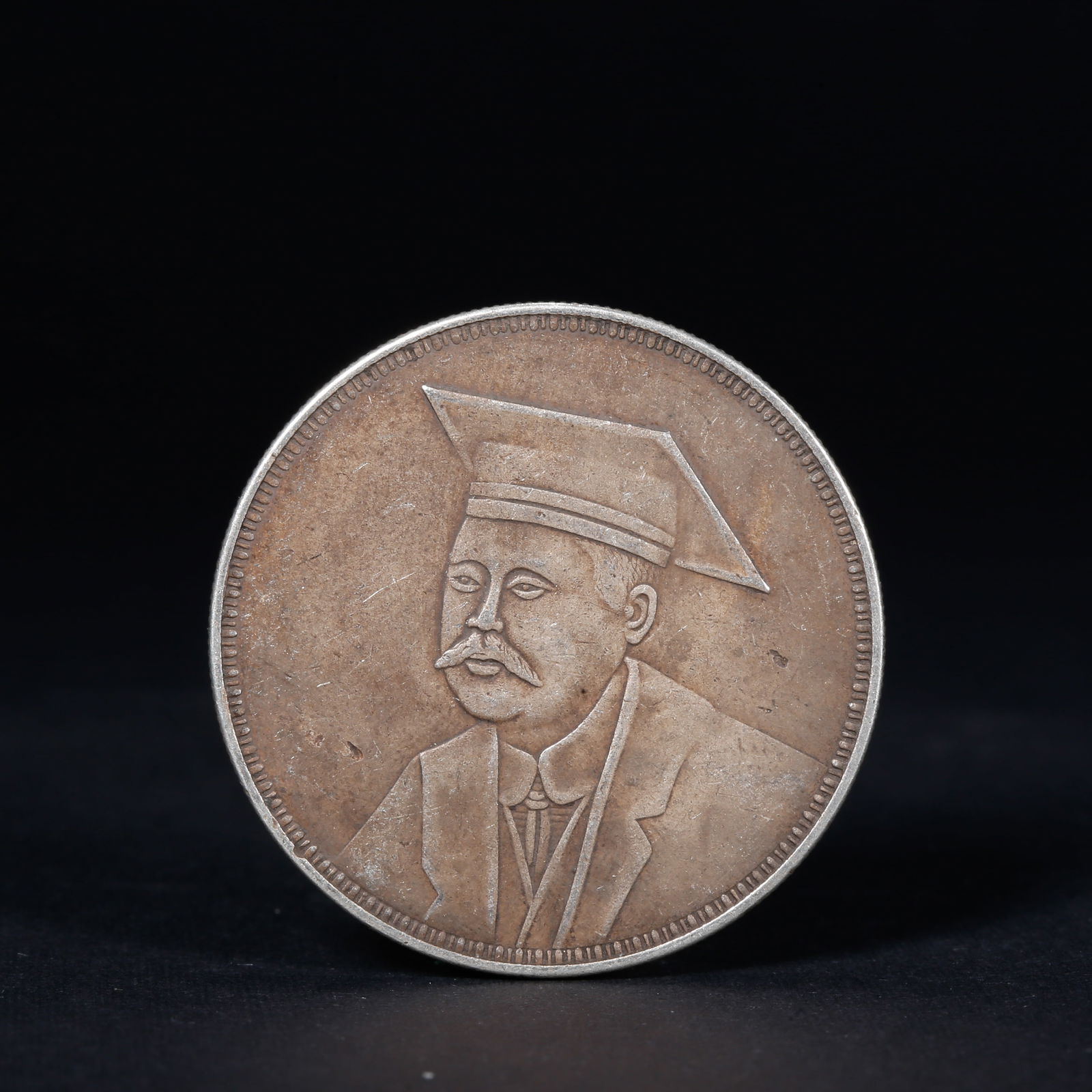 A SILVER DOLLAR COIN: One Silver dollar Coin