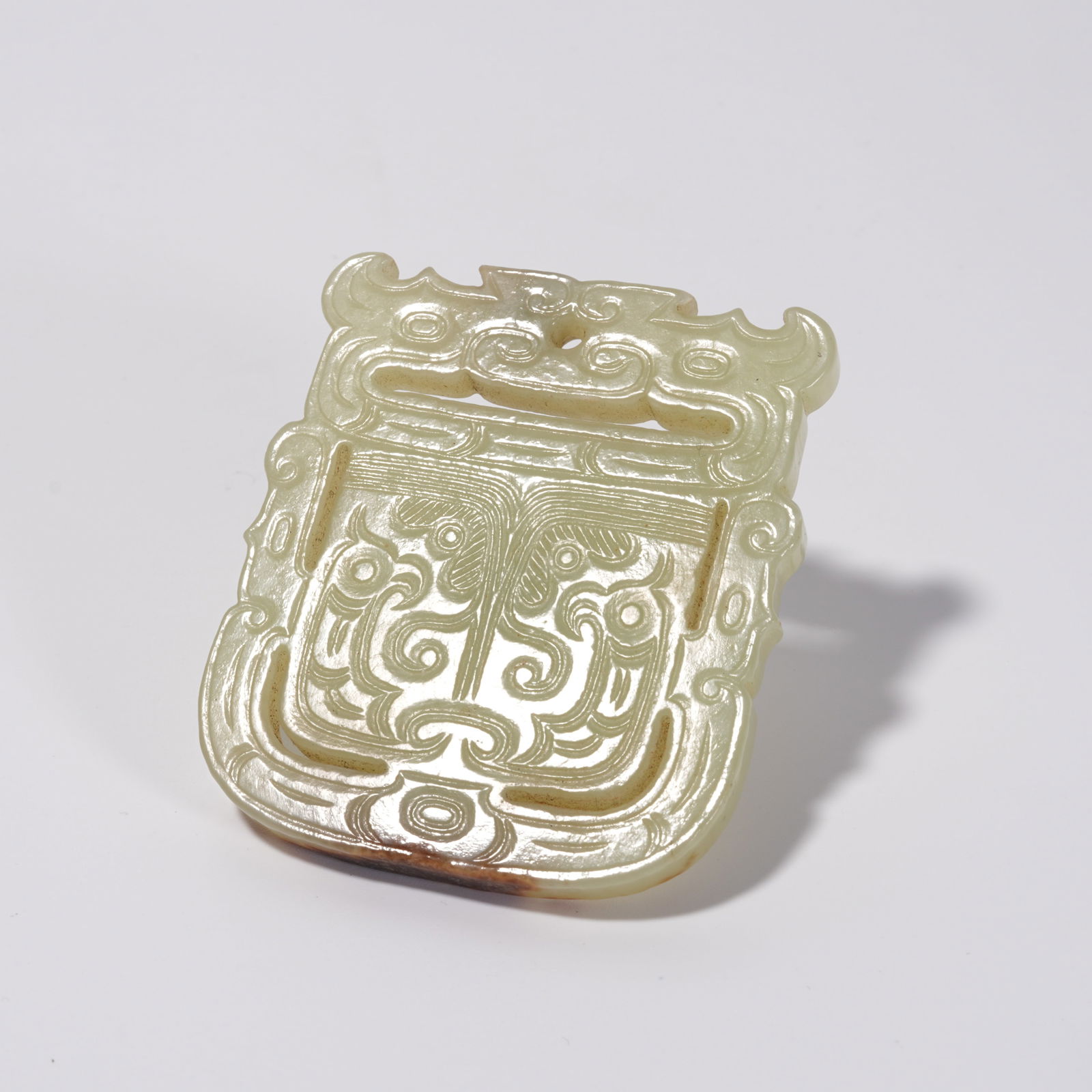 A HETIAN JADE BEAST-FACE PENDANT: Hetian Jade Beast-Face Pendant