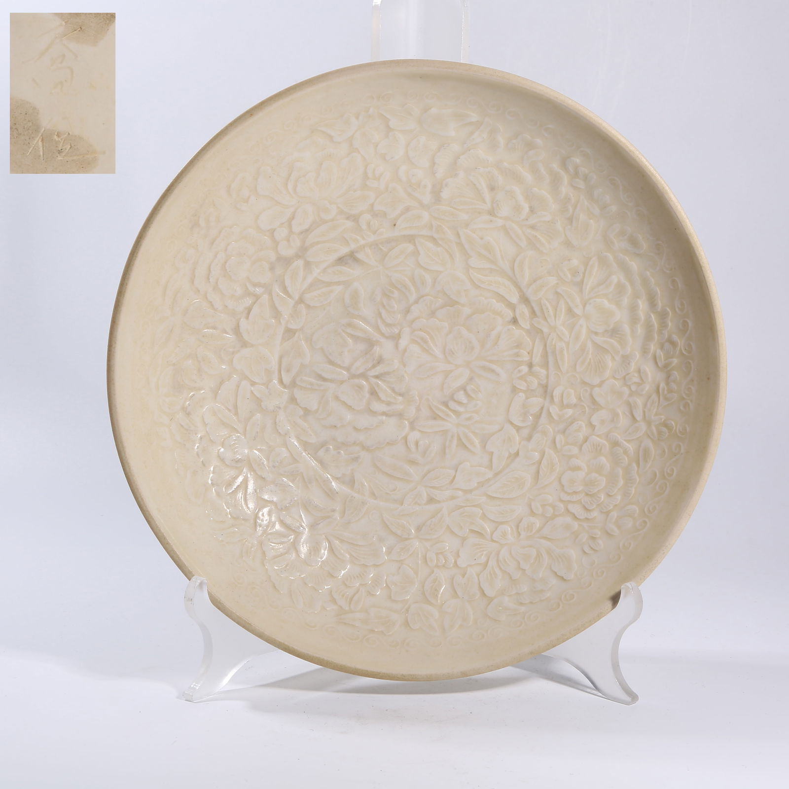 A DING KILN CARVED FLORAL PATTERNED DISH: Ding kiln carved floral patterned dish
