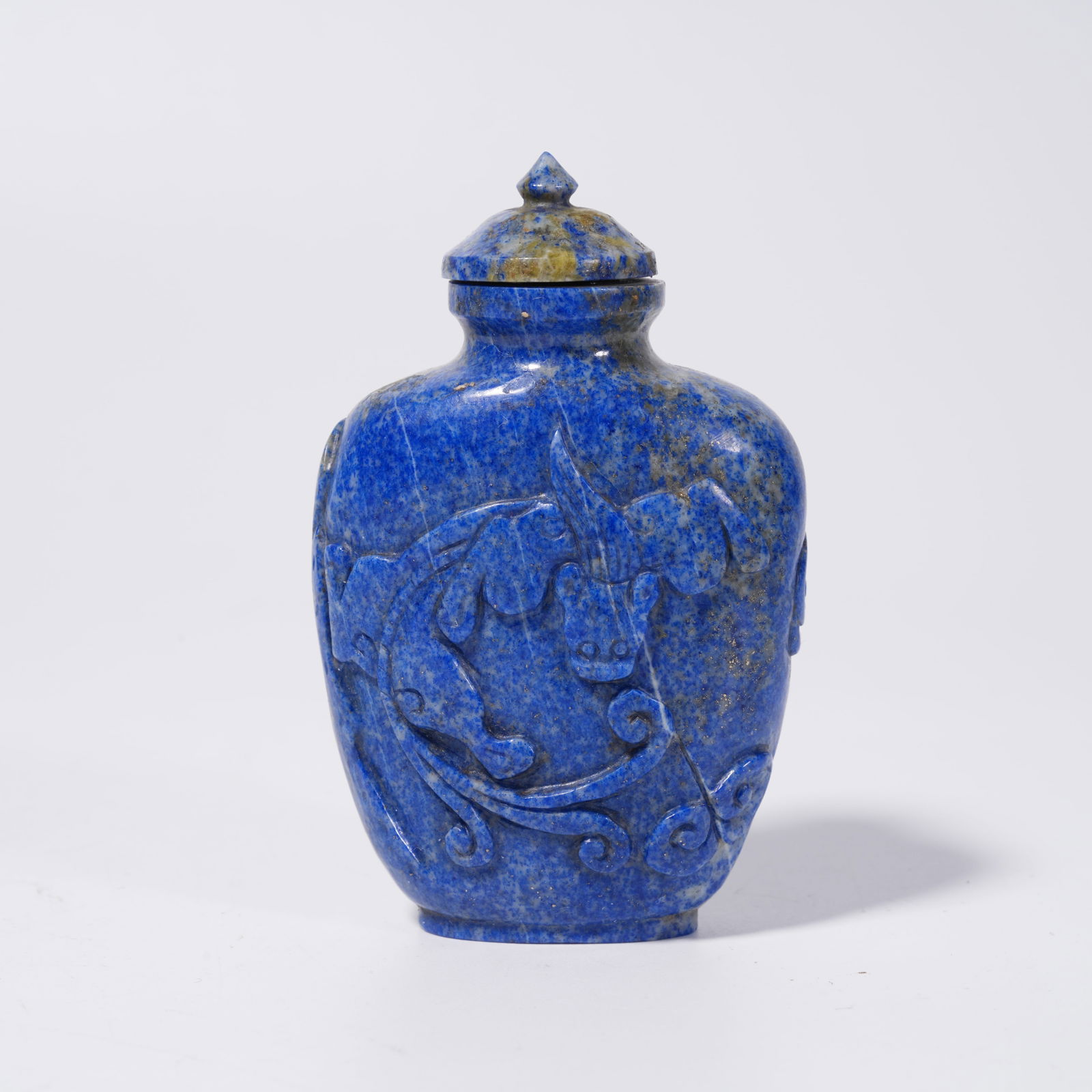 A LAPIS LAZULI SNUFF BOTTLE WITH BEAST PATTERN: Lapis Lazuli Snuff Bottle with Beast Pattern