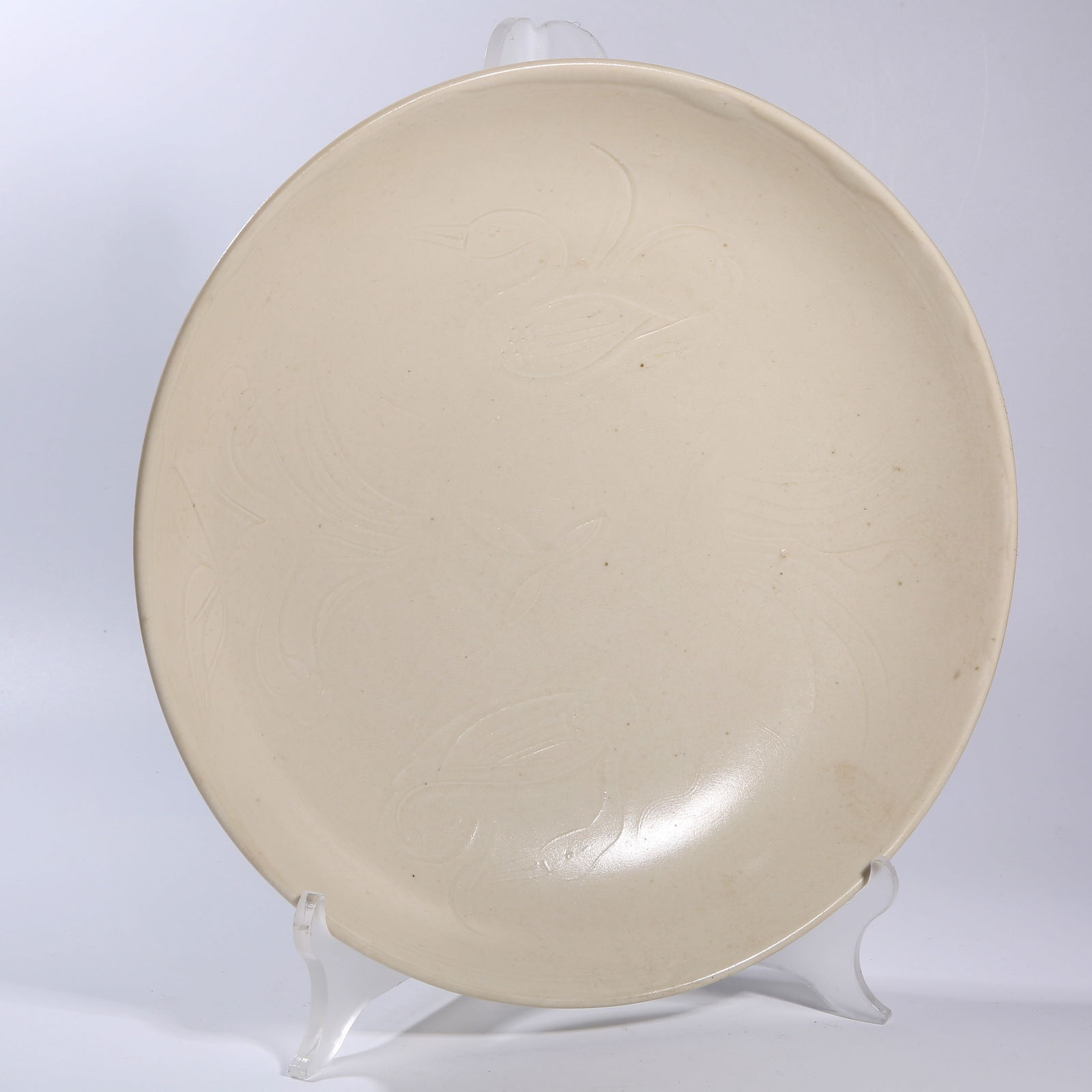 A DING KILN INCISED DUCK-AND-GRASS PATTERNED DISH: Ding kiln incised duck-and-grass patterned dish