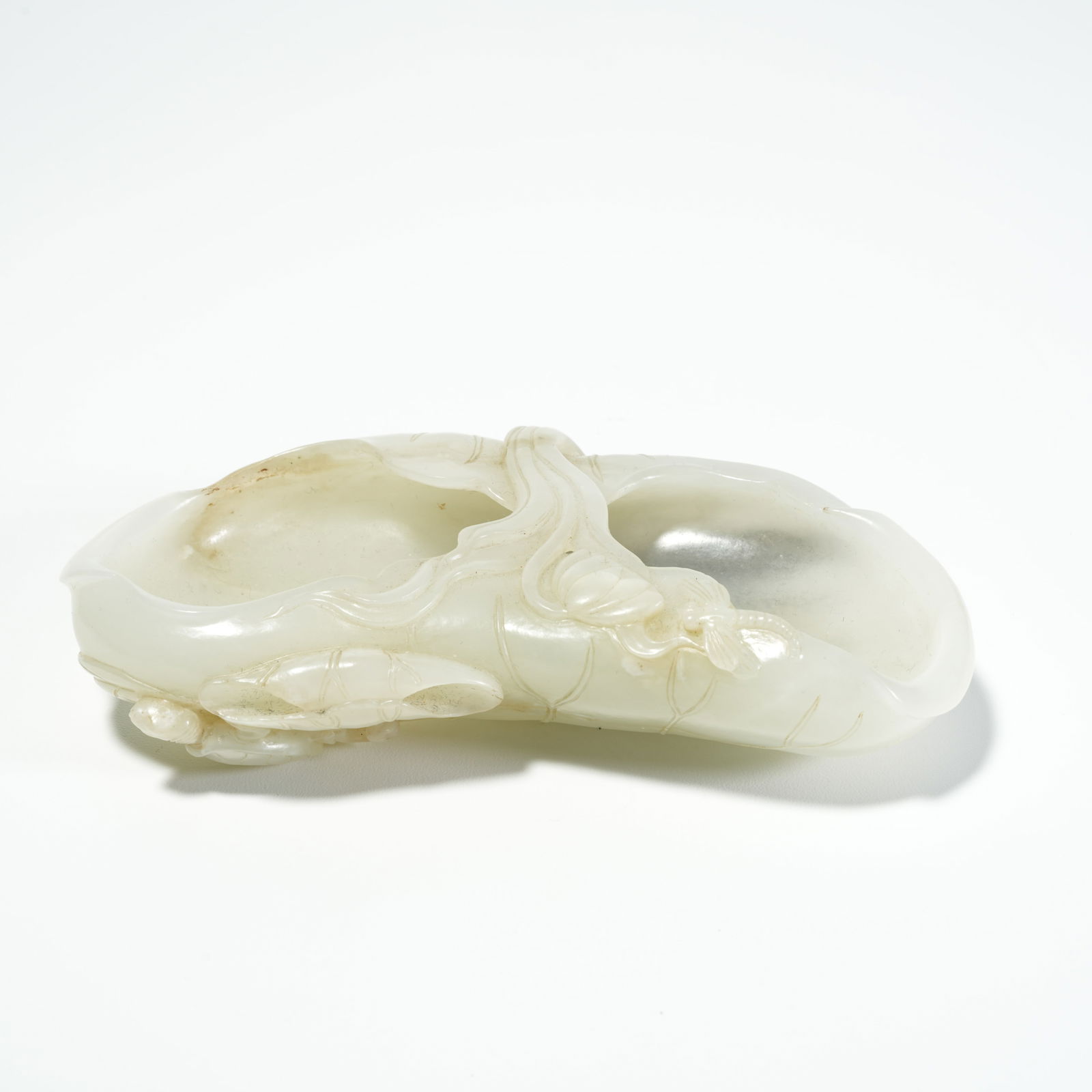 A HETIAN JADE LOTUS-LEAF WASH BASIN: Hetian Jade Lotus-Leaf Wash Basin