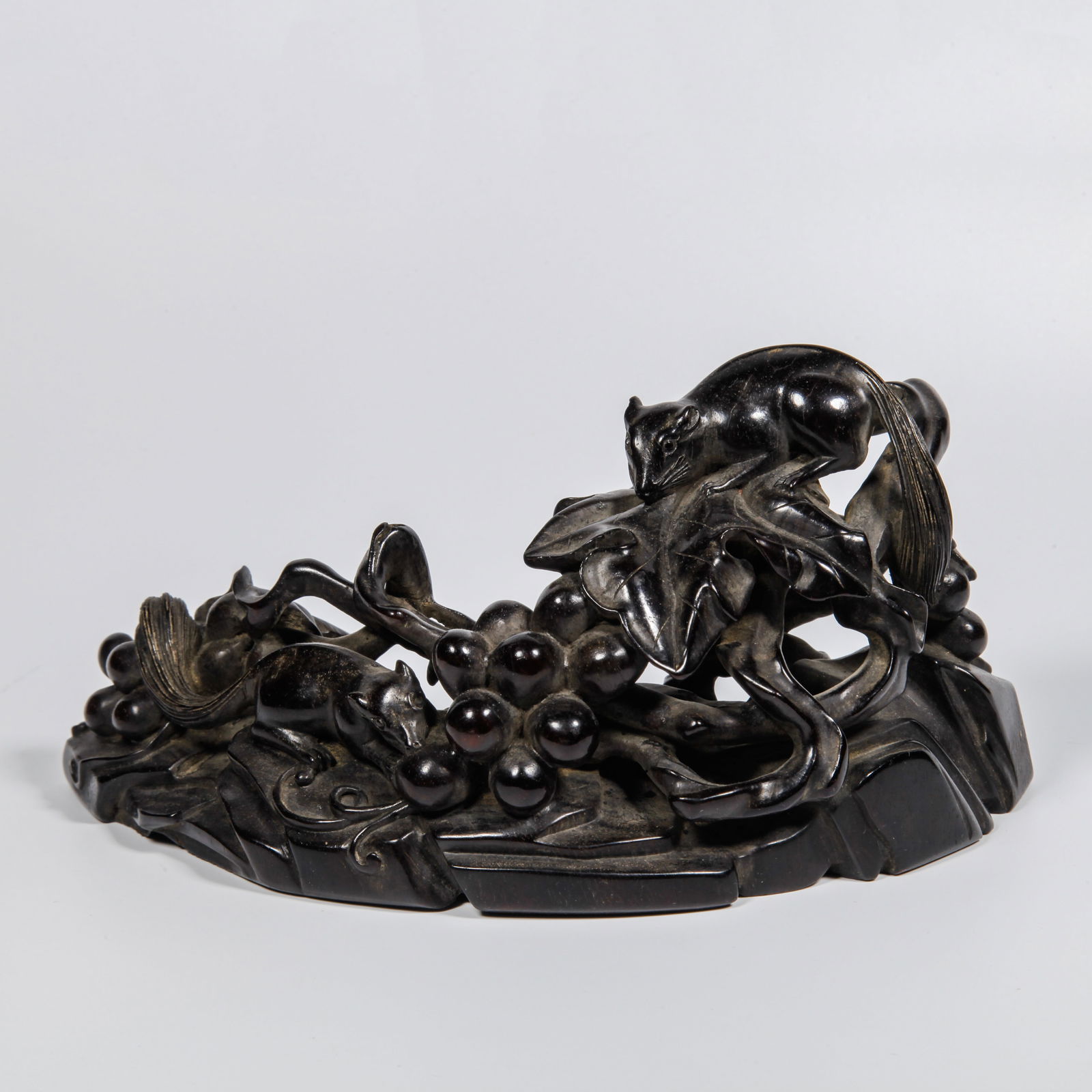 A ZITAN WOOD CARVED SQUIRREL AND GRAPE PATTERN BRUSH RACK: Zitan Wood Carved Squirrel and Grape Pattern Brush Rack