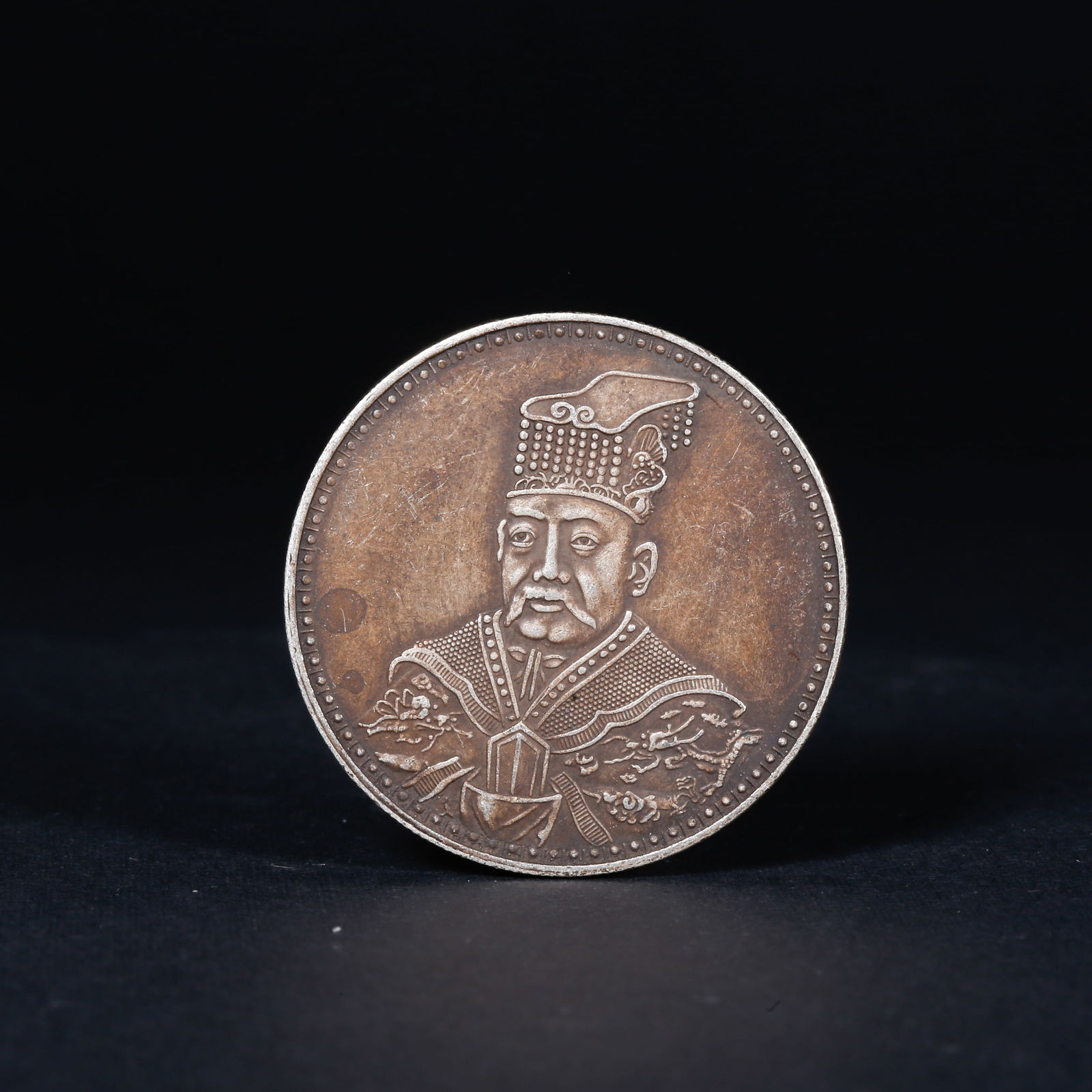 A SILVER DOLLAR COIN: One Silver dollar Coin