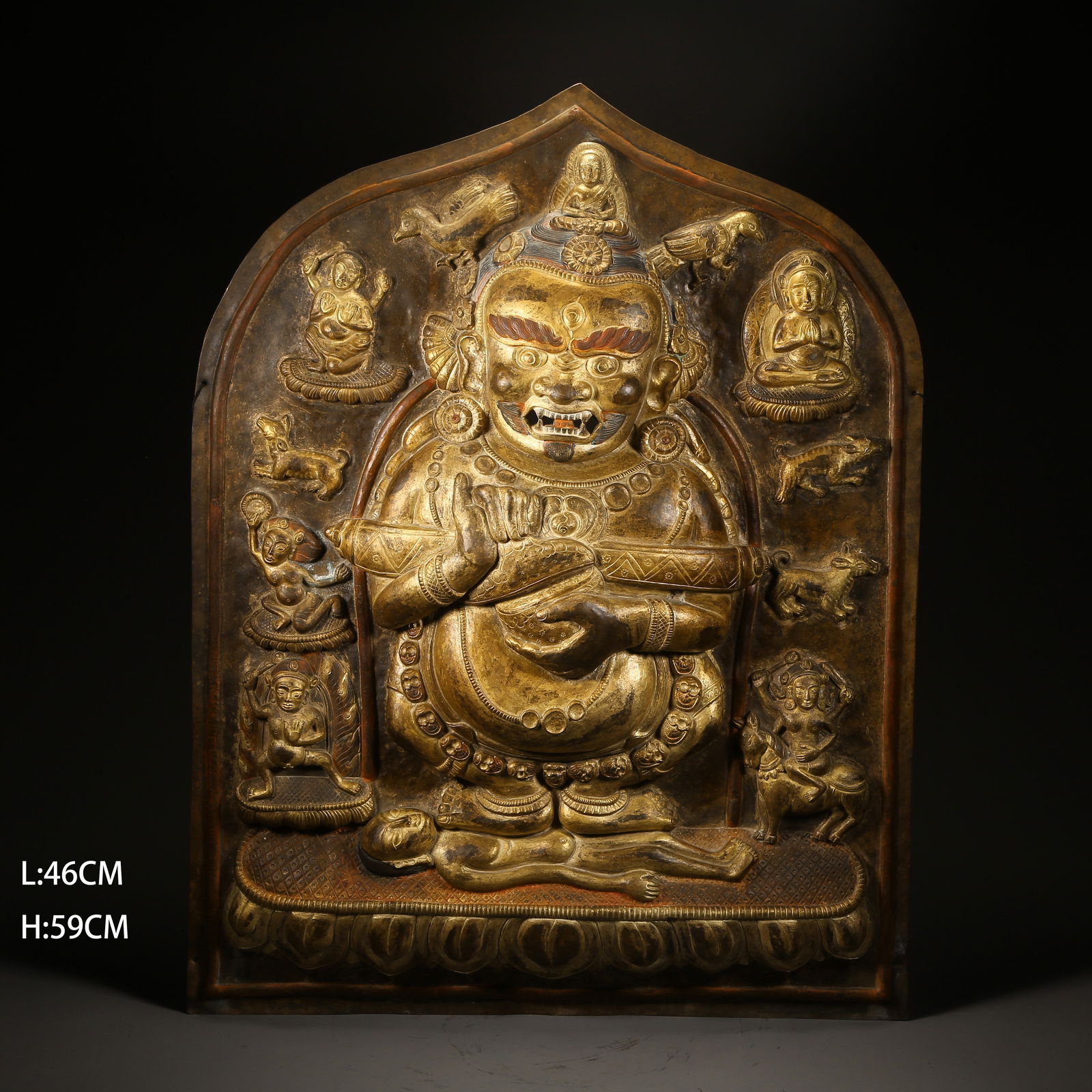 A GILDED BRONZE HAMMERED VAJRA-HOLDING DEITY PLAQUE: Gilded bronze hammered Vajra-holding deity plaque