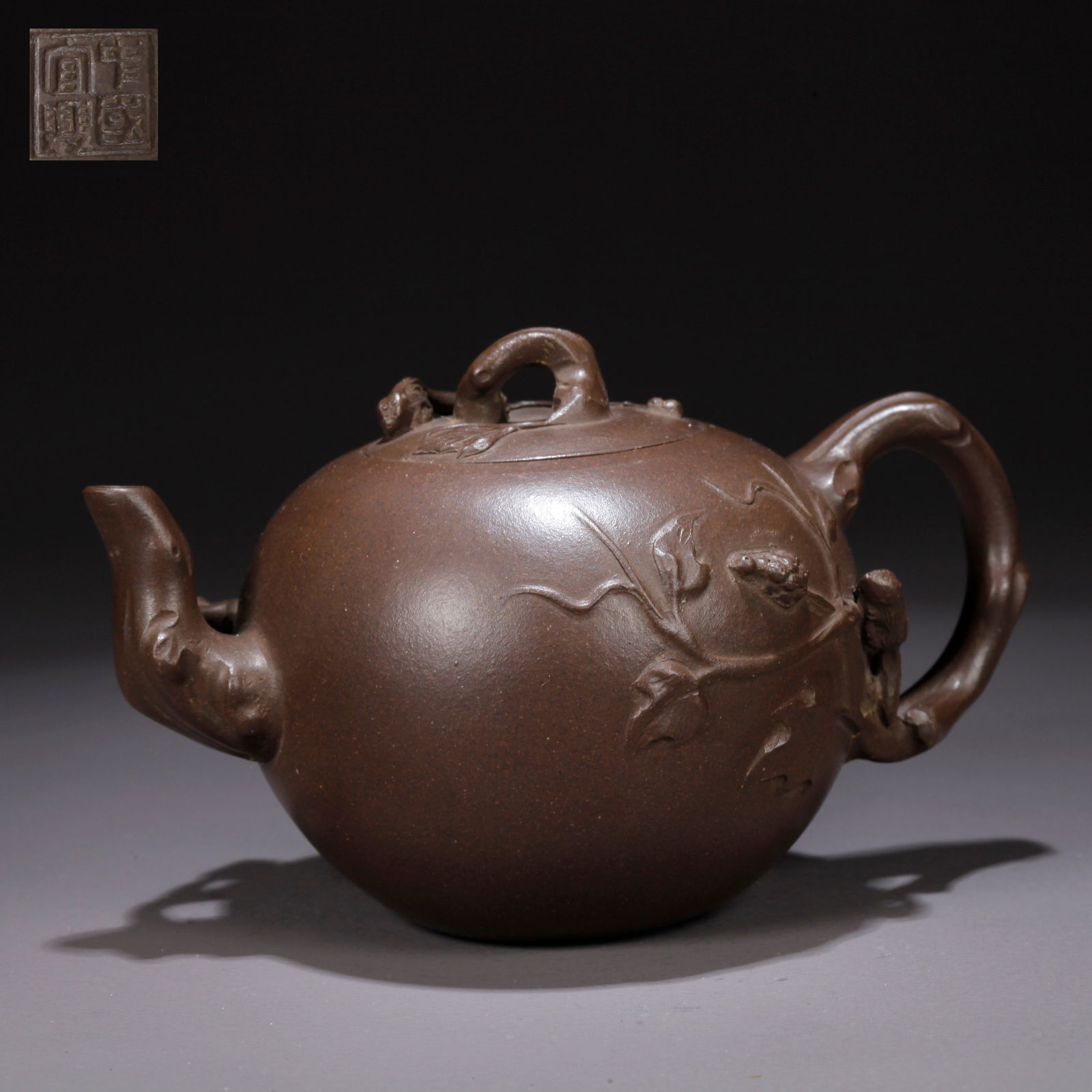 A PURPLE CLAY (ZISHA) TEAPOT WITH SQUIRREL-AND-GRAPES MOTIF: Purple Clay (Zisha) Teapot with Squirrel-and-Grapes Motif