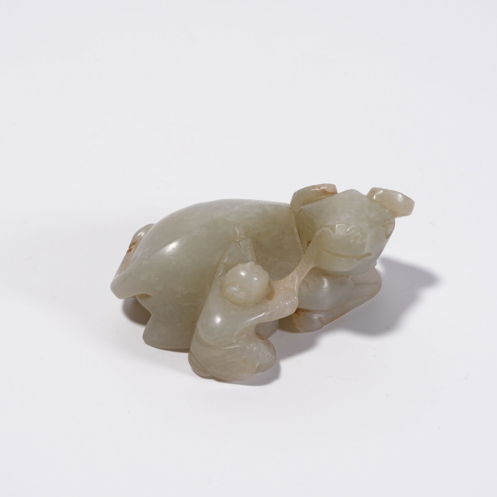 A HETIAN JADE CHILD FIGURE WITH OX ORNAMENT: Hetian Jade Child Figure with Ox Ornament