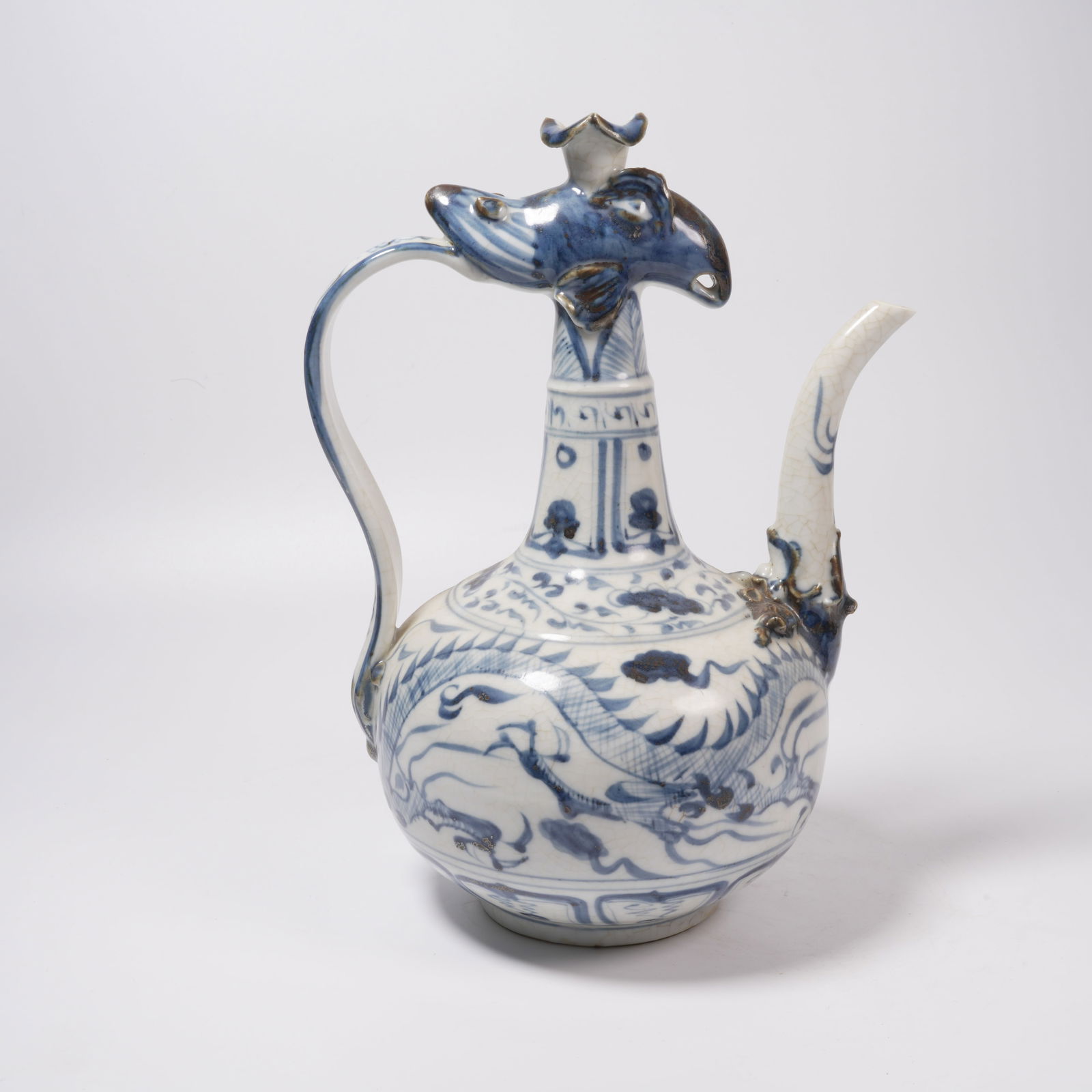 A BLUE-AND-WHITE CLOUD-AND-DRAGON PHOENIX-HEAD EWER: Blue-and-White Cloud-and-Dragon Phoenix-Head Ewer