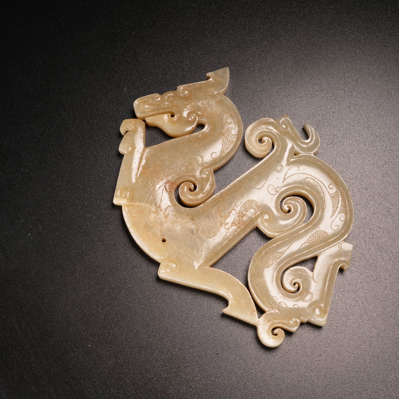 A S-DRAGON PENDANT IN ARCHAIC JADE: S-Dragon Pendant in Archaic Jade