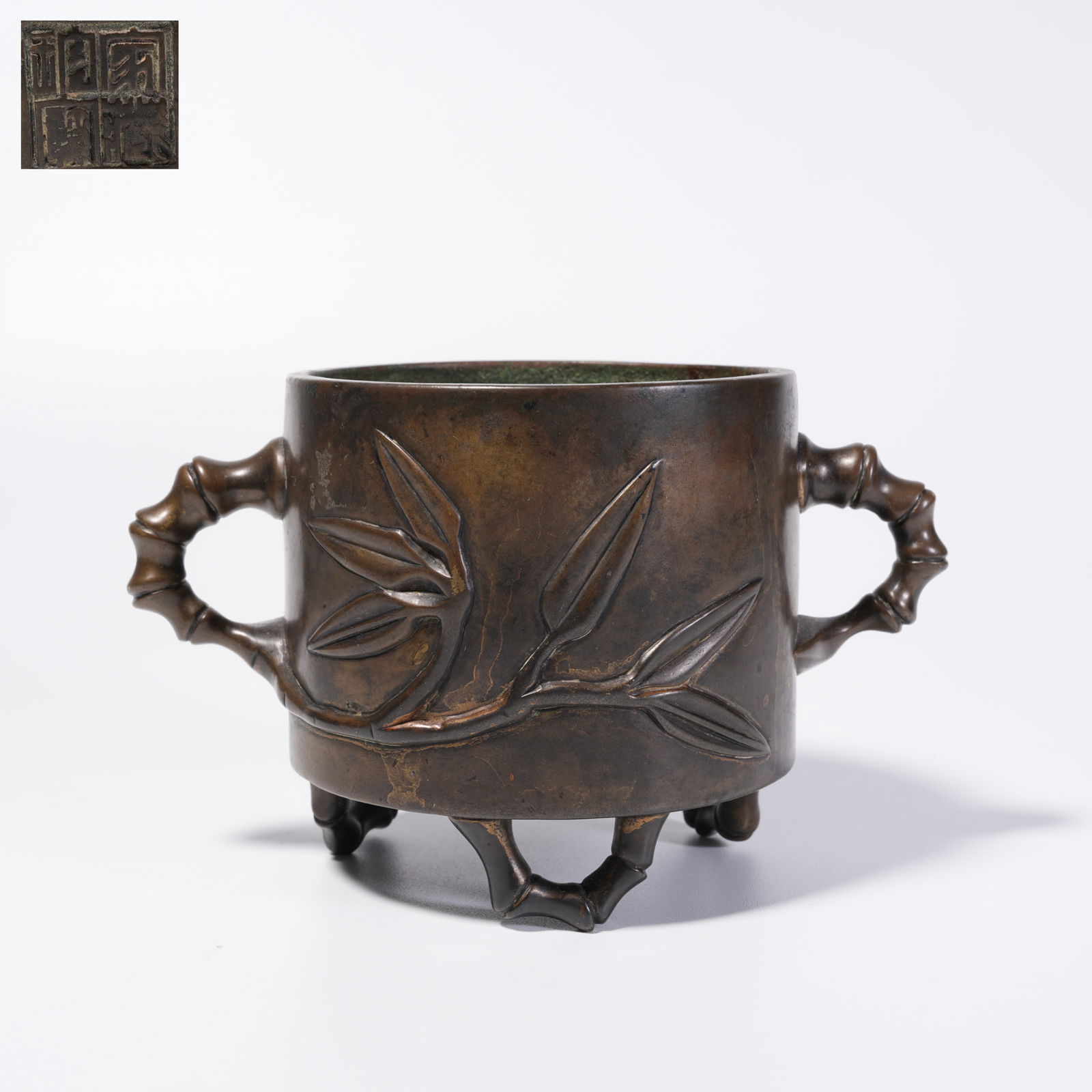 A BRONZE TRIPOD CENSER WITH DOUBLE BRIDGE HANDLES: Bronze Tripod Censer with Double Bridge Handles