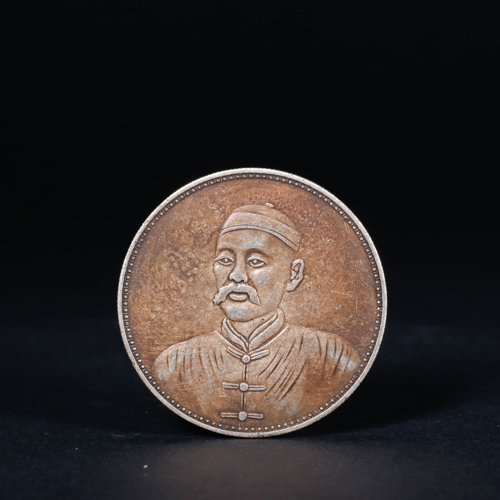 A SILVER DOLLAR COIN: One Silver dollar Coin