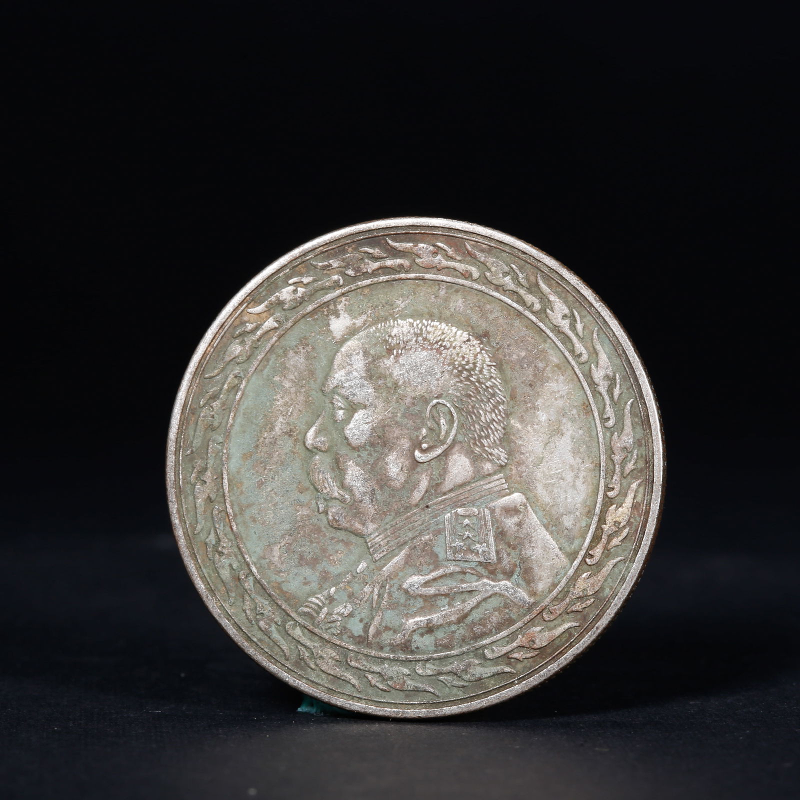 A SILVER DOLLAR COIN: One Silver dollar Coin