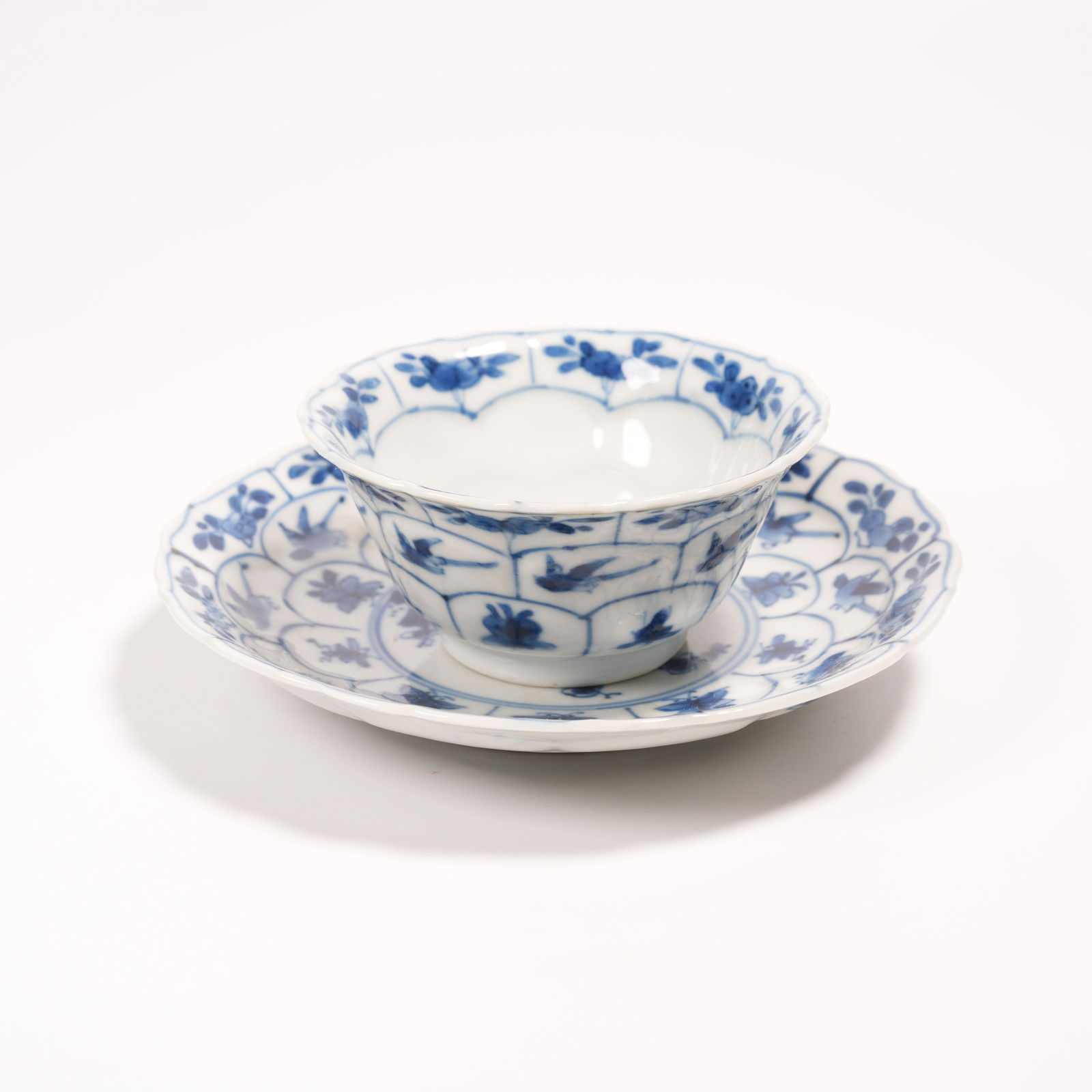 A BLUE-AND-WHITE FLOWER-AND-BIRD CUP STANDS (SET): Blue-and-White Flower-and-Bird Cup Stands (Set)