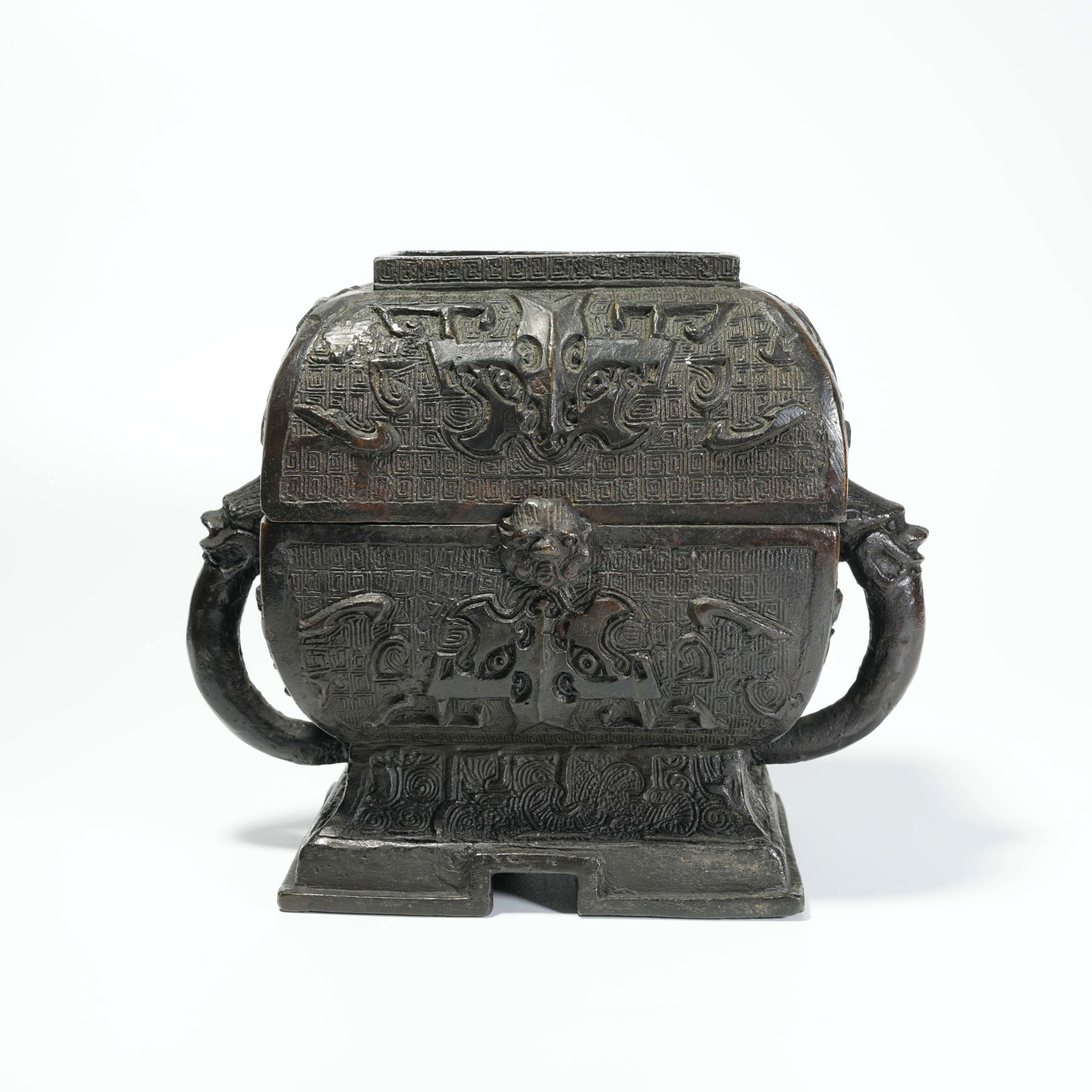 A BRONZE DOUBLE-BEAST-HANDLED BOX WITH BEAST-FACE PATTERN: Bronze Double-Beast-Handled Box with Beast-Face Pattern
