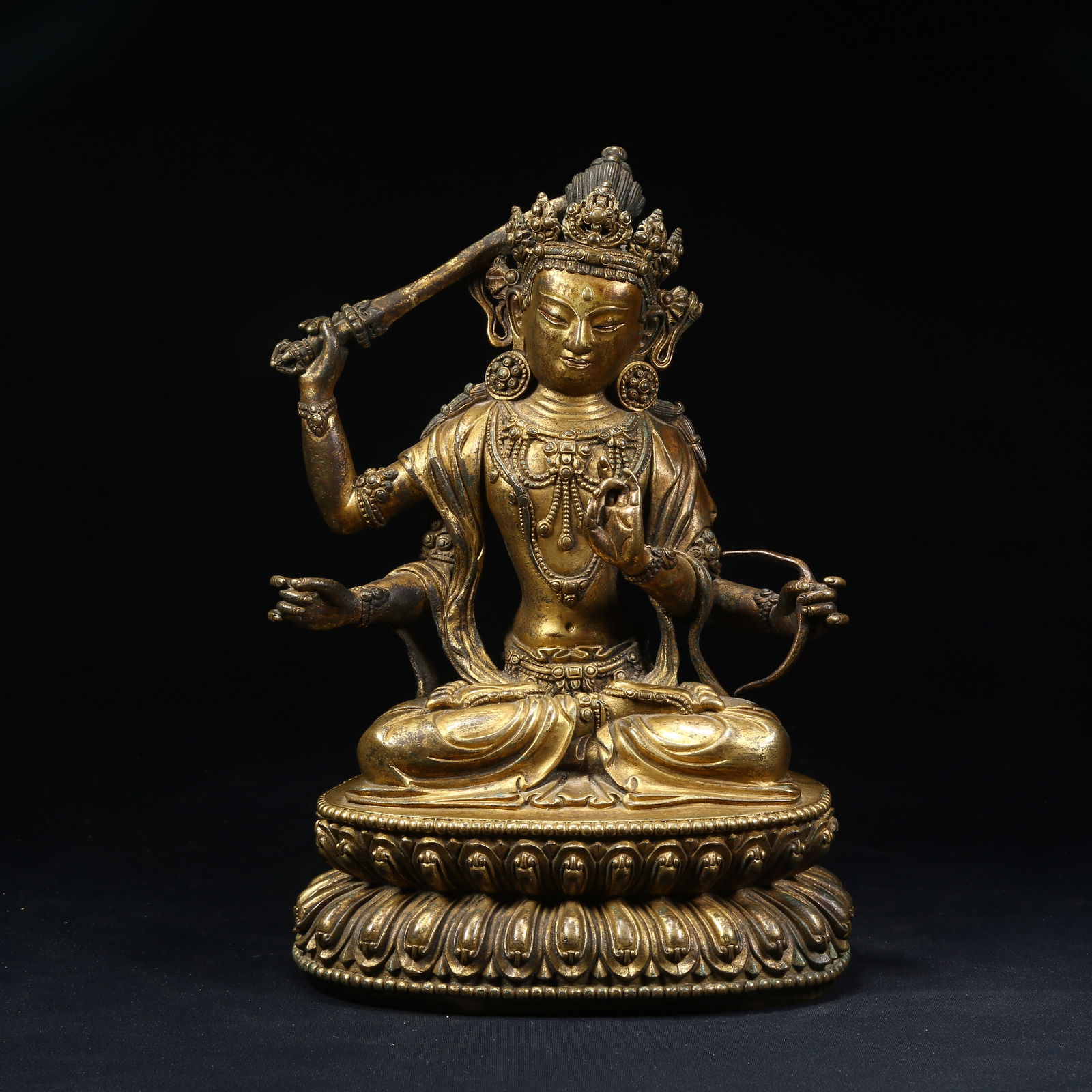 A GILT BRONZE FOUR-ARMED MANJUSHRI BODHISATTVA STATUE: Gilt Bronze Four-Armed Manjushri Bodhisattva Statue