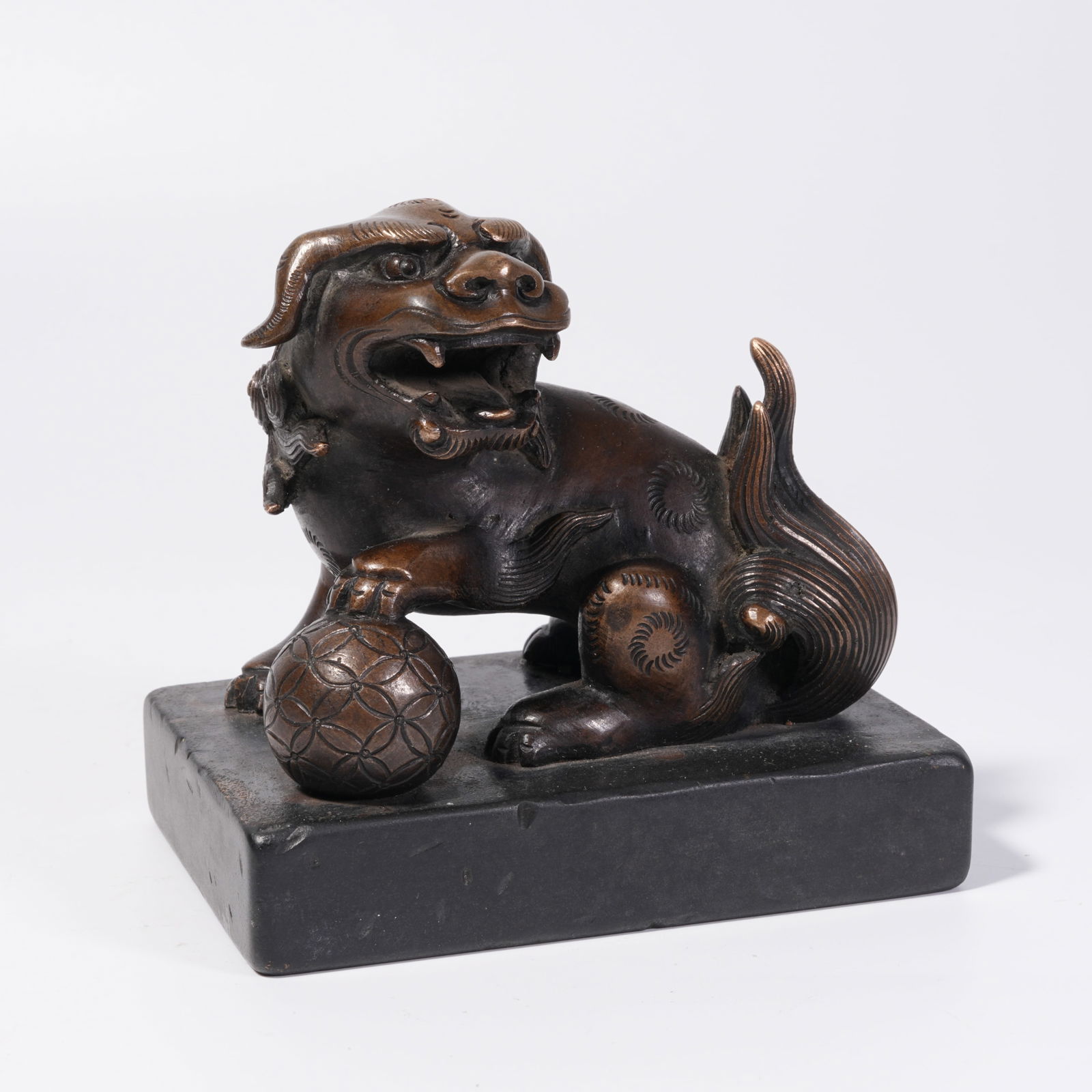 A BRONZE PAPERWEIGHT WITH LION FINIAL ROLLING BALL: Bronze Paperweight with Lion Finial Rolling Ball