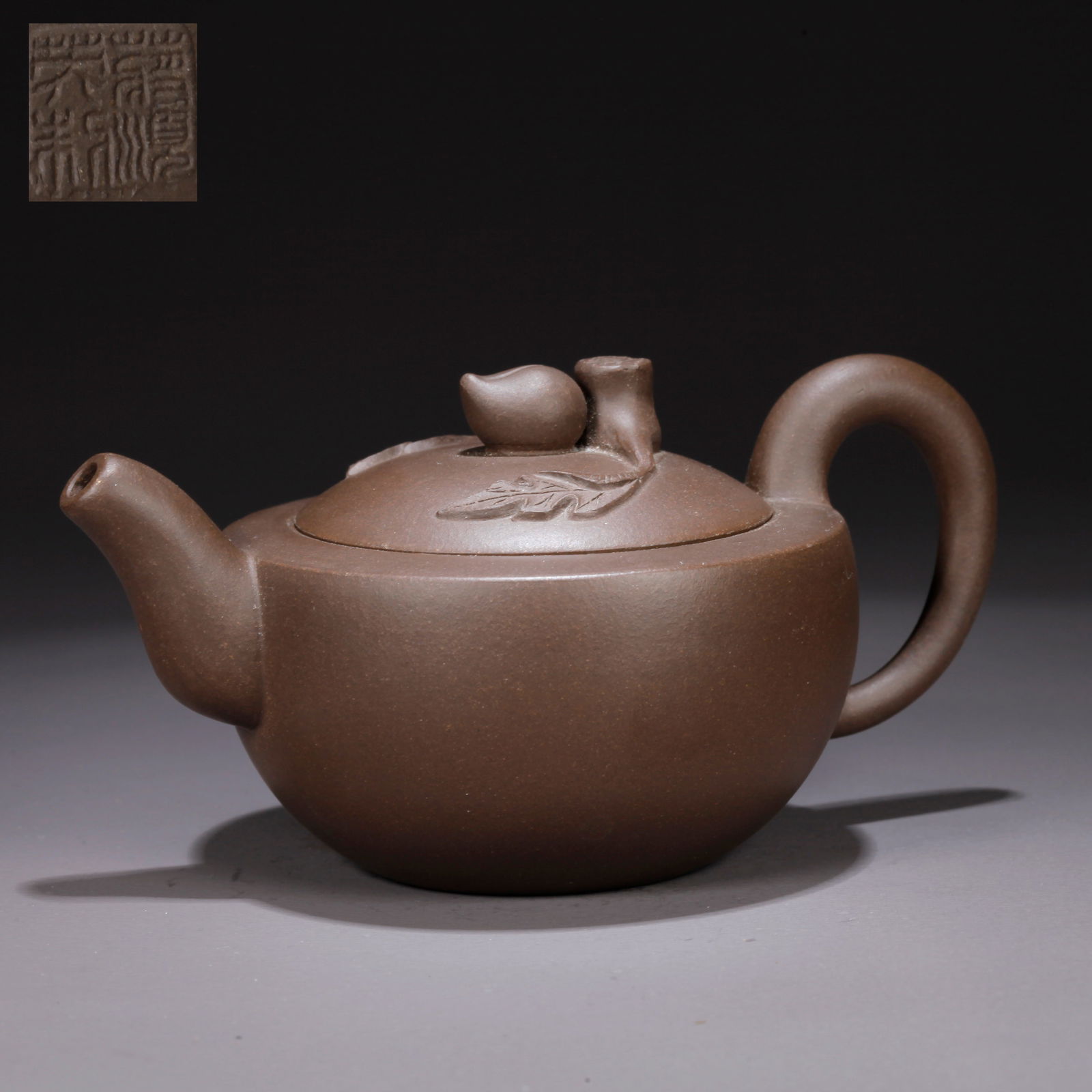 A PURPLE CLAY (ZISHA) TEAPOT WITH PEACH KNOB: Purple Clay (Zisha) Teapot with Peach Knob