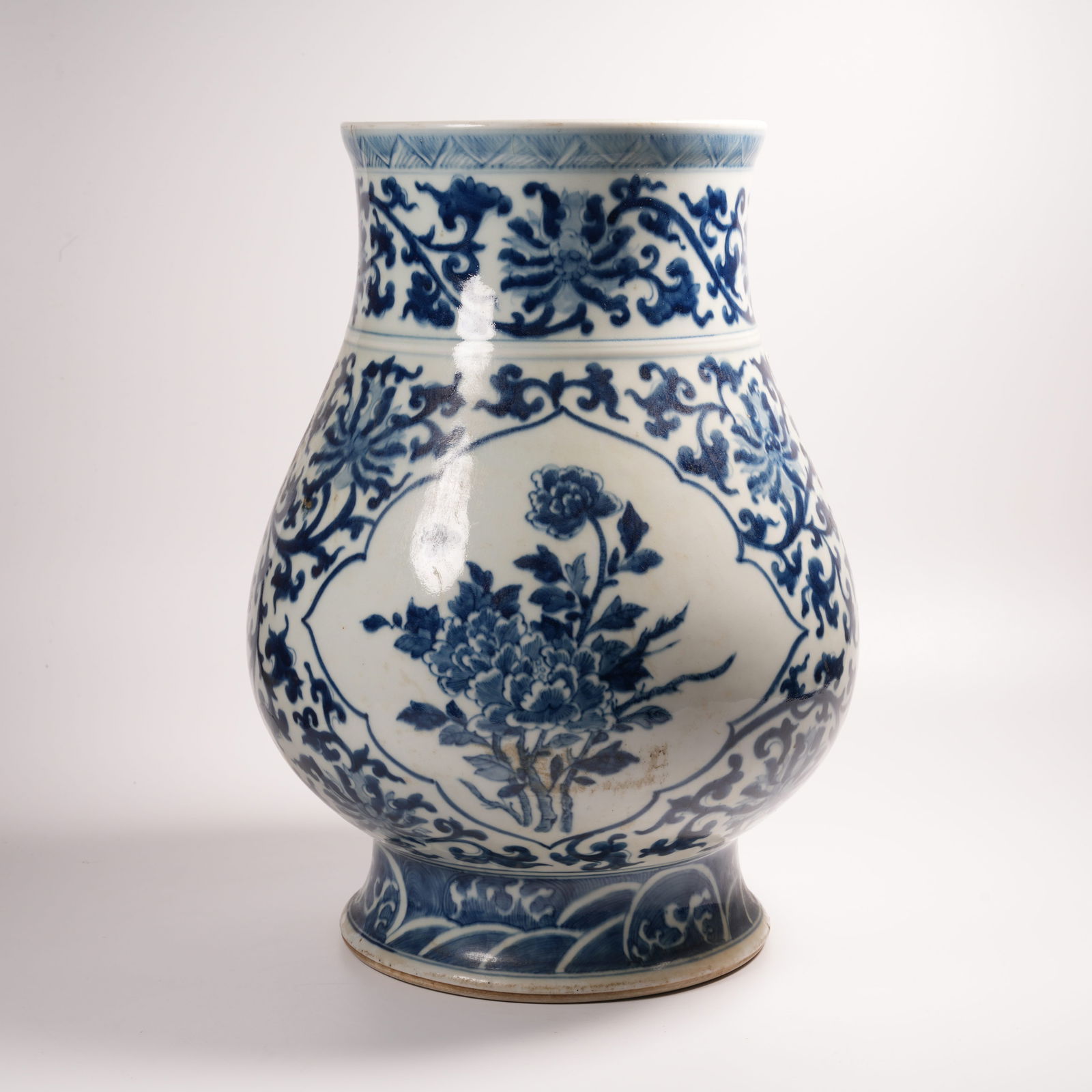 A BLUE-AND-WHITE ZUN WITH FLOWER AND BUTTERFLY PATTERN: Blue-and-White Zun with Flower and Butterfly Pattern