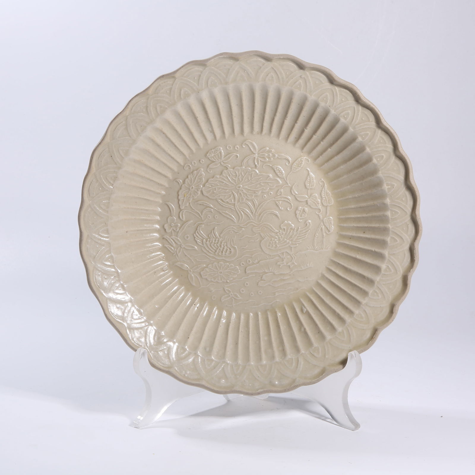 A DING KILN CARVED LOTUS POND AND MANDARIN DUCK PATTERNED FLARED-MOUTH DISH: Ding kiln carved lotus pond and mandarin duck patterned flared-mouth dish
