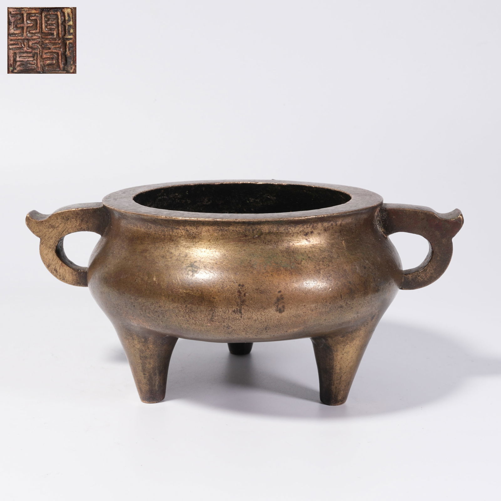 A BRONZE DOUBLE-HANDLED TRIPOD CENSER: Bronze Double-Handled Tripod Censer