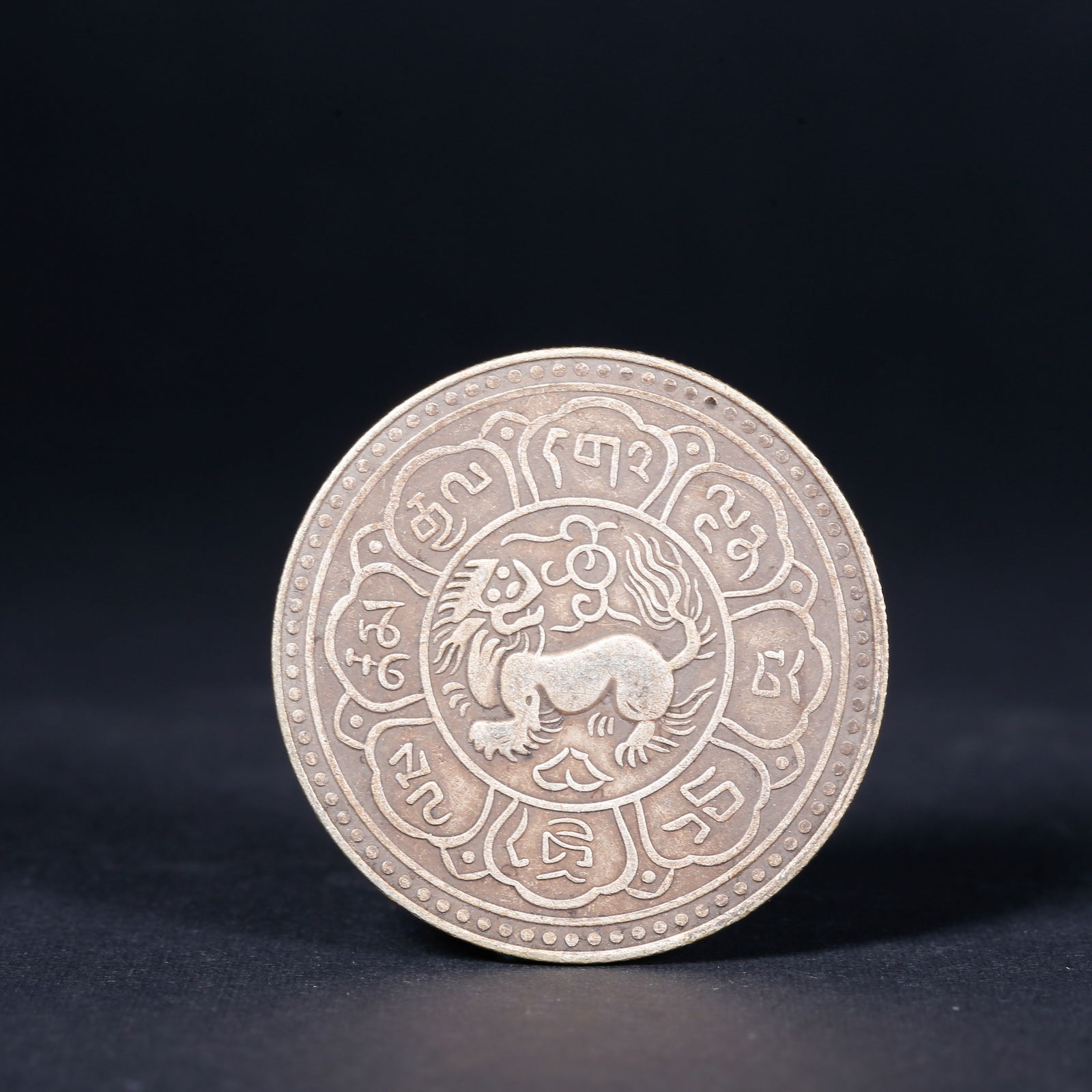 A SILVER DOLLAR COIN: One Silver dollar Coin