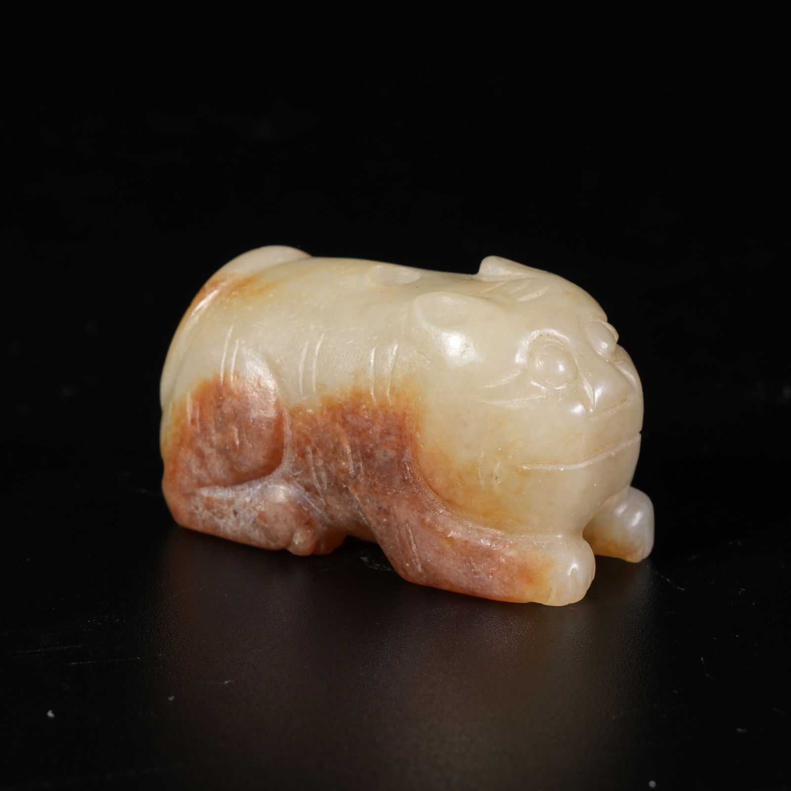 A HETIAN JADE TIGER-SHAPED PENDANT: Hetian Jade Tiger-Shaped Pendant
