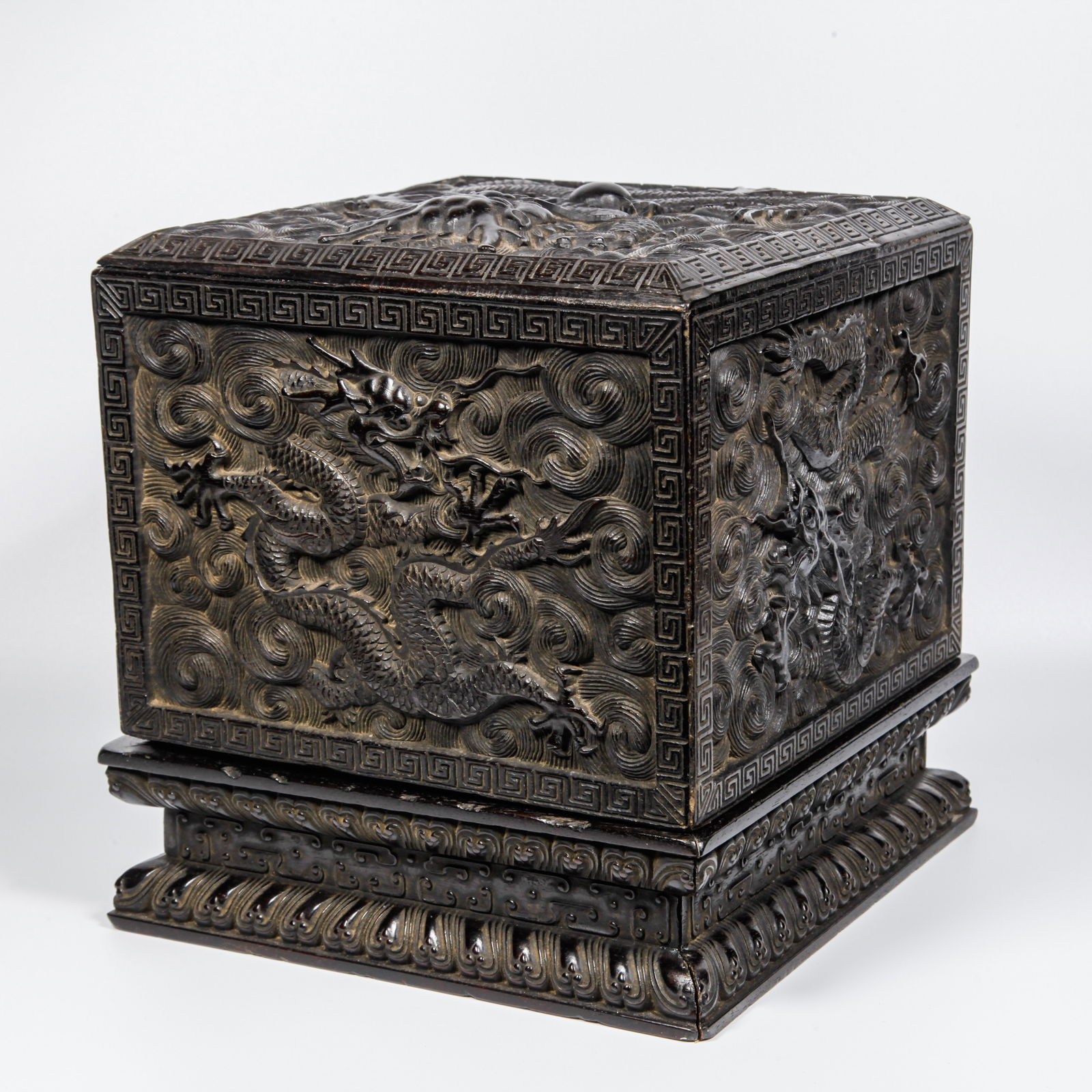 A ZITAN WOOD CARVED CLOUD AND DRAGON PATTERN COVERED BOX: Zitan Wood Carved Cloud and Dragon Pattern Covered Box