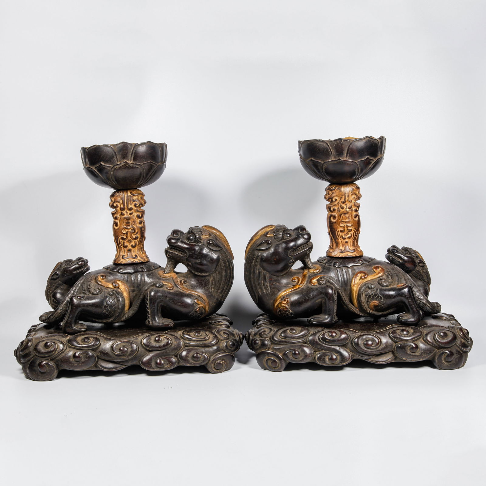A ZITAN WOOD CARVED CHI-TIGER SHAPED CANDLESTICK PAIR: Zitan Wood Carved Chi-Tiger Shaped Candlestick Pair