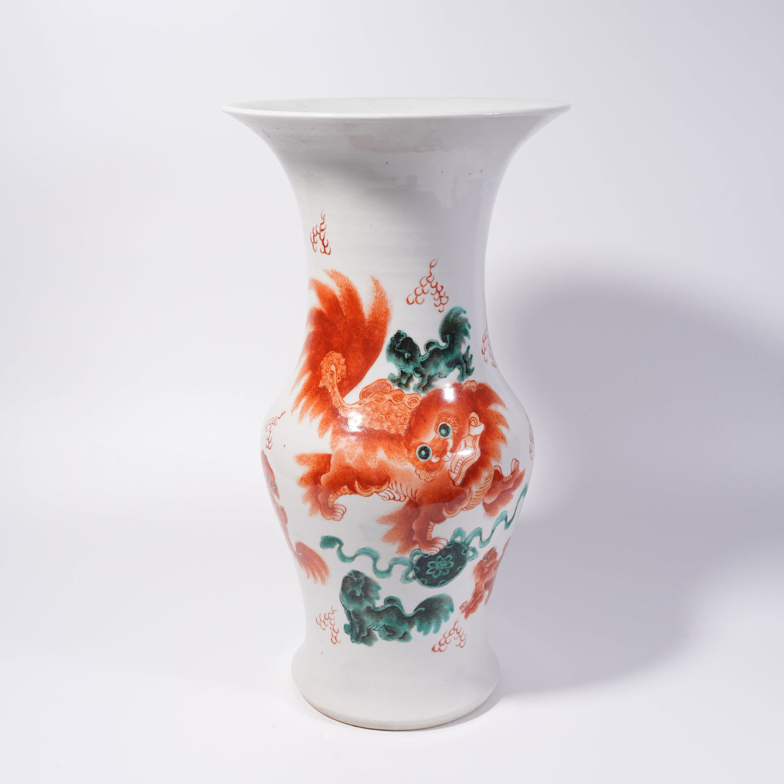 A UNDERGLAZE RED HU-FORM VASE WITH LION AND BALL PATTERN: Underglaze Red Hu-Form Vase with Lion and Ball Pattern