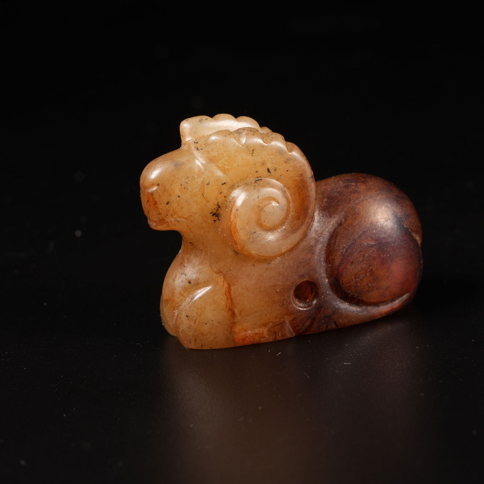A ANCIENT JADE RECLINING SHEEP PENDANT: Ancient Jade Reclining Sheep Pendant