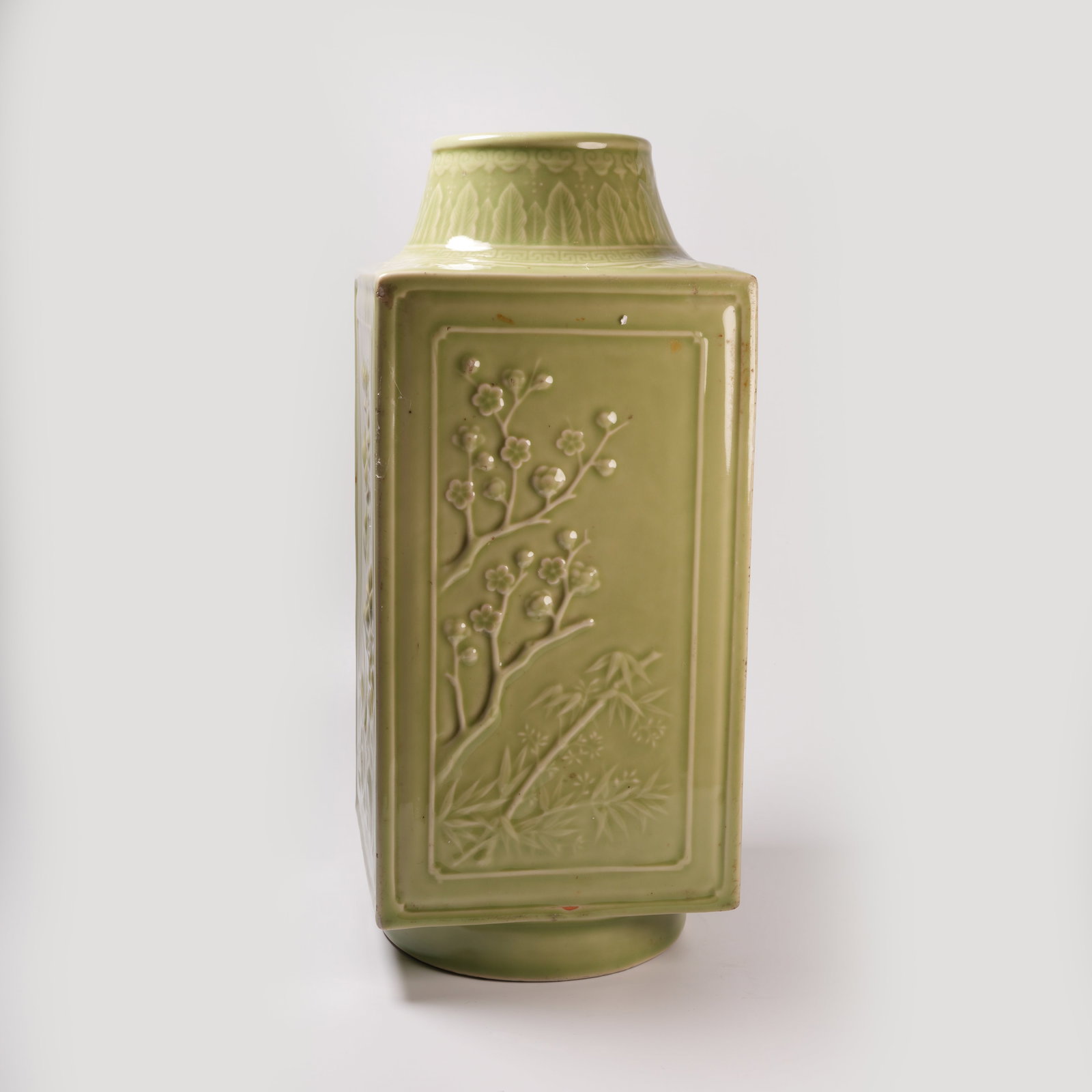 A CELADON-GLAZED CONG-FORM VASE WITH FLORAL MOTIF (1 of 9)