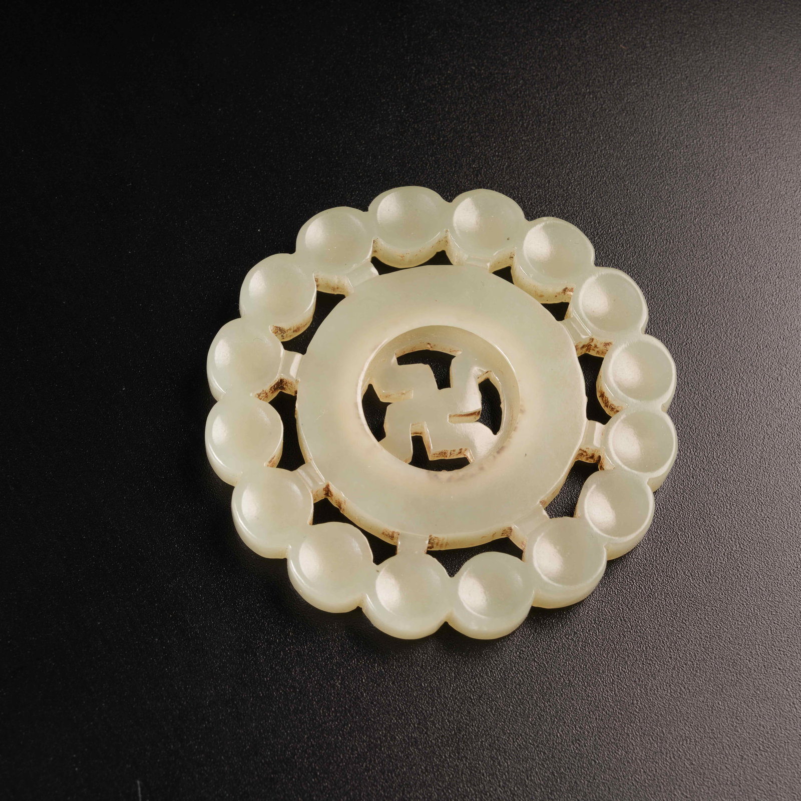 A HETIAN JADE SWASTIKA PENDANT: Hetian Jade Swastika Pendant