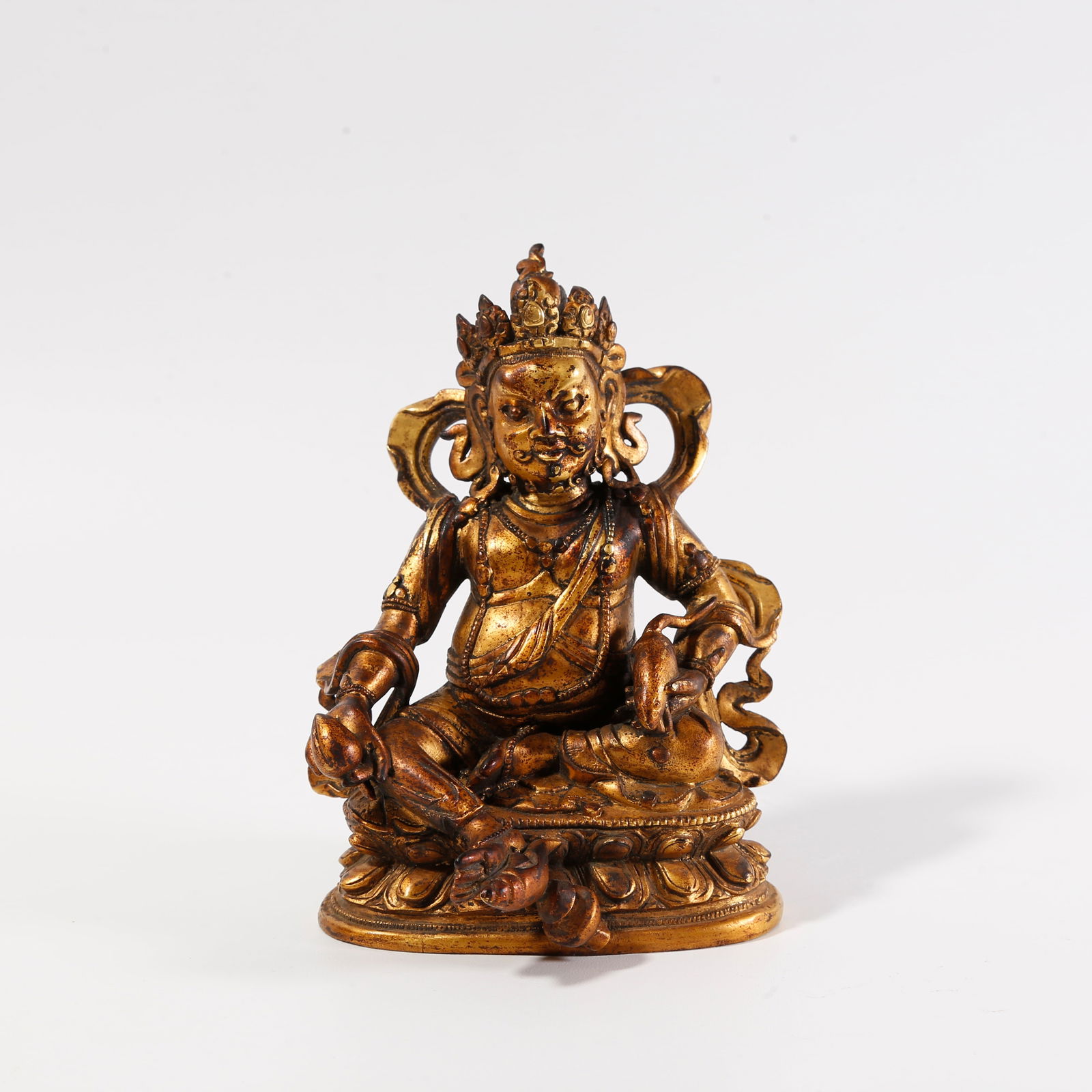 A GILT-BRONZE STATUE OF THE YELLOW GOD OF WEALTH: Gilt-bronze statue of the Yellow God of Wealth