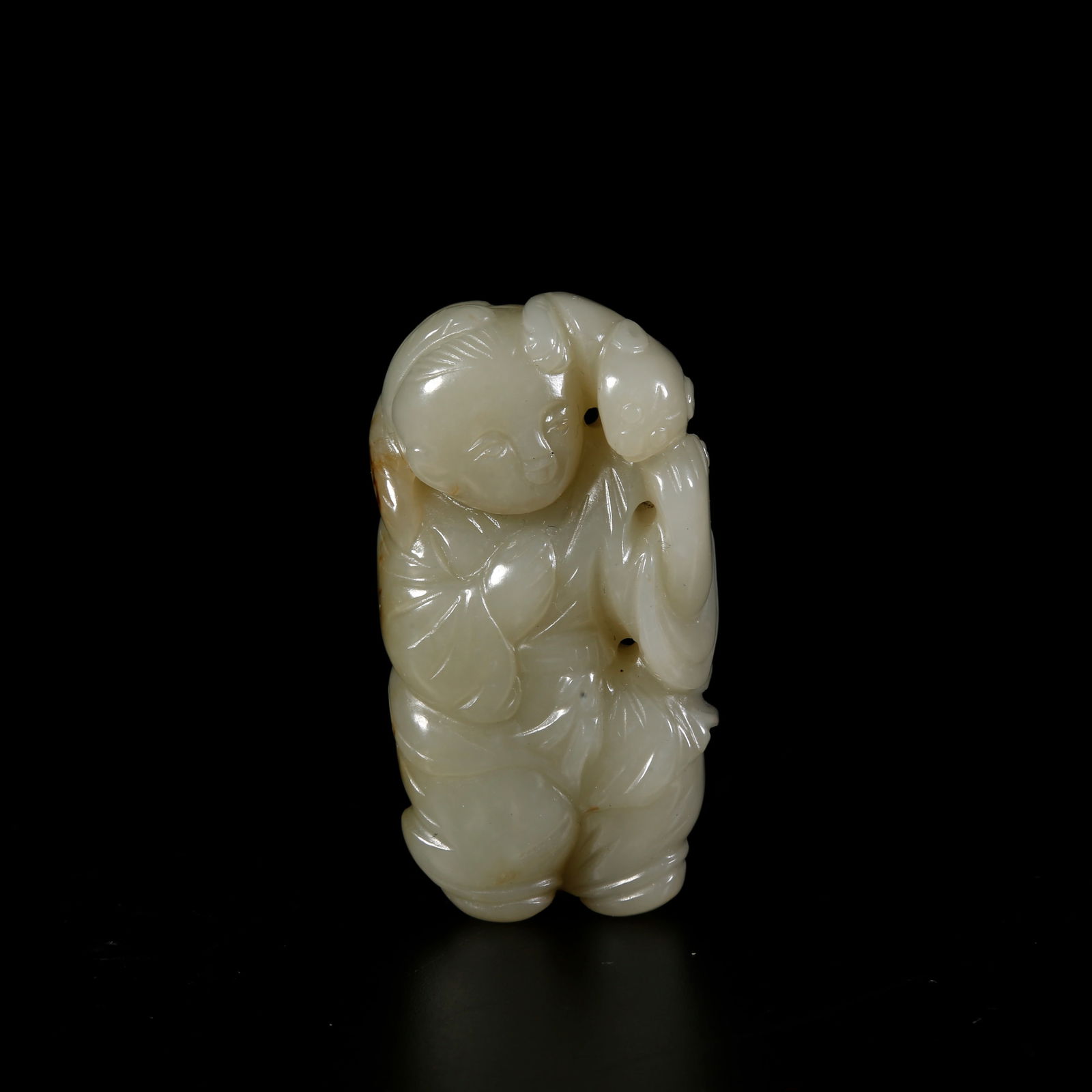 A HETIAN JADE ORNAMENT OF LIU HAI PLAYING WITH THE GOLDEN TOAD: Hetian jade ornament of Liu Hai playing with the golden toad