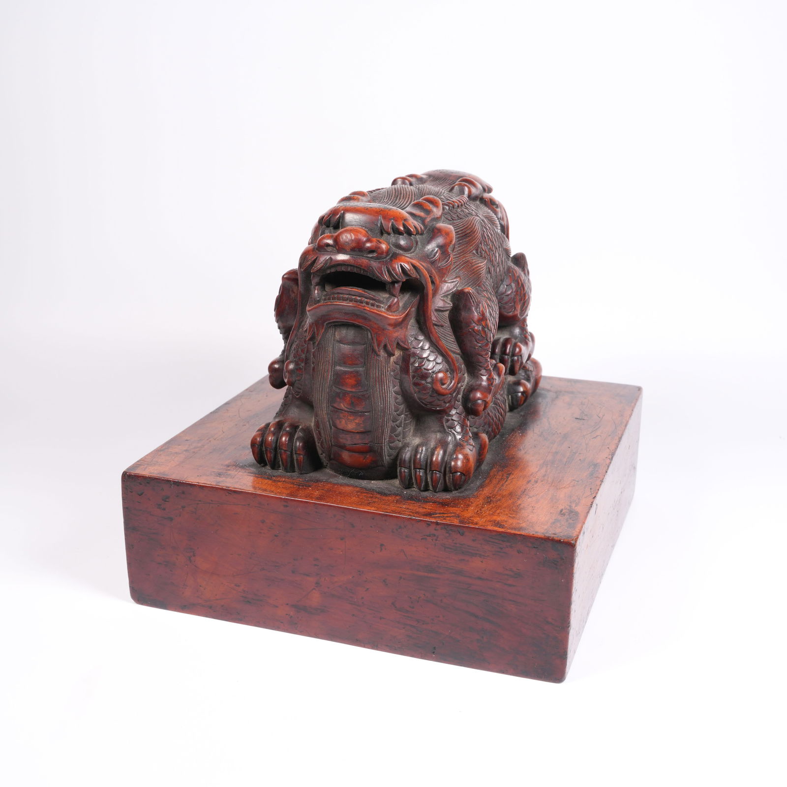 A HUANGHUALI DRAGON-HANDLE LARGE SEAL: Huanghuali Dragon-Handle Large Seal