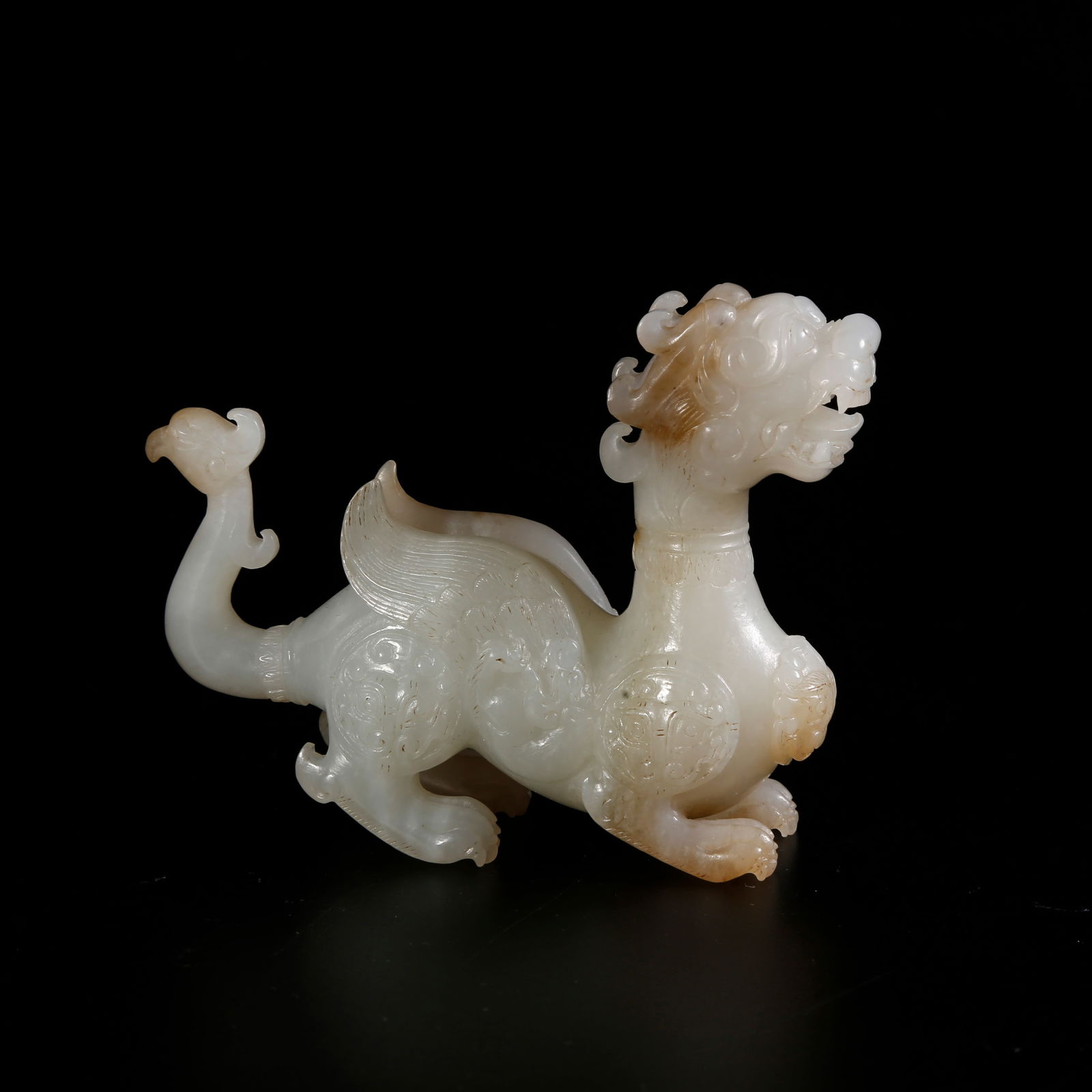 A HETIAN JADE CHI-TIGER-SHAPED ORNAMENT: Hetian jade chi-tiger-shaped ornament