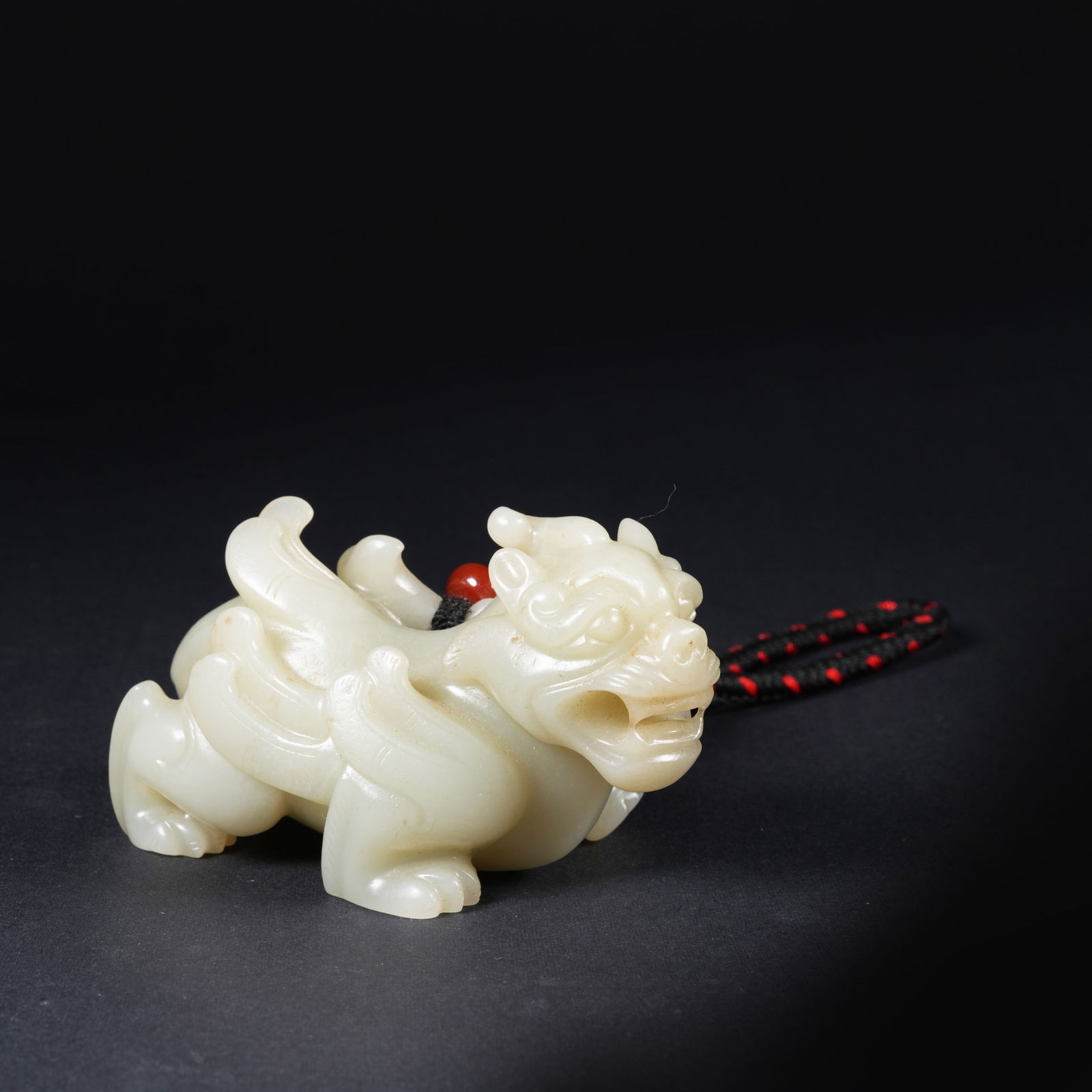 A HETIAN JADE MYTHICAL-BEAST PENDANT: Hetian jade mythical-beast pendant