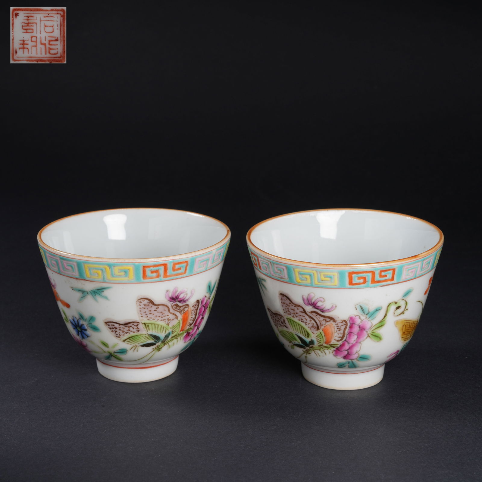 A SET OF FAMILLE-ROSE FLOWER-AND-BUTTERFLY CUPS: Set of famille-rose flower-and-butterfly cups