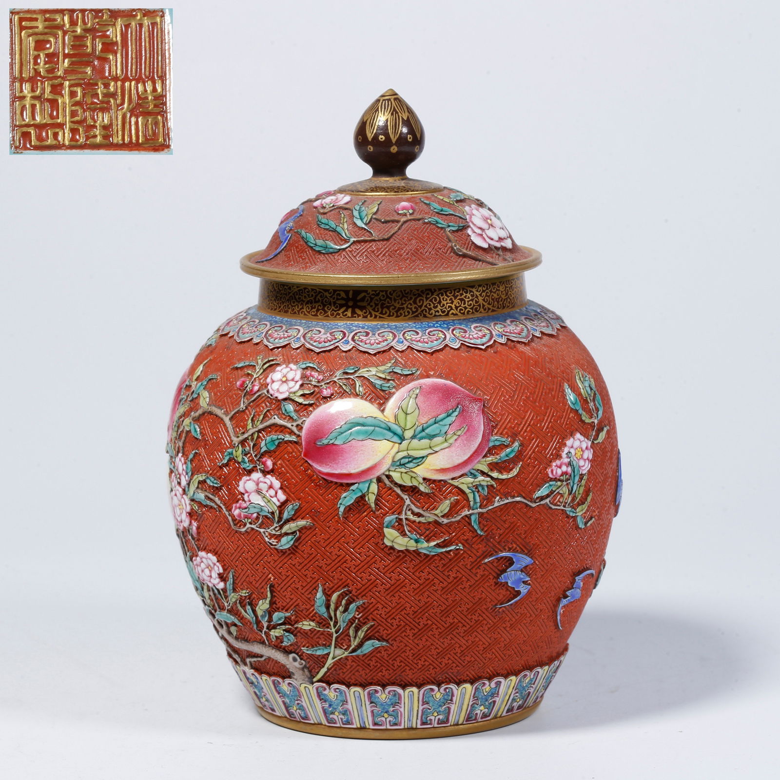 A BRONZE-GLAZED LIDDED JAR WITH LONGEVITY PEACH MOTIF: Bronze-glazed lidded jar with longevity peach motif