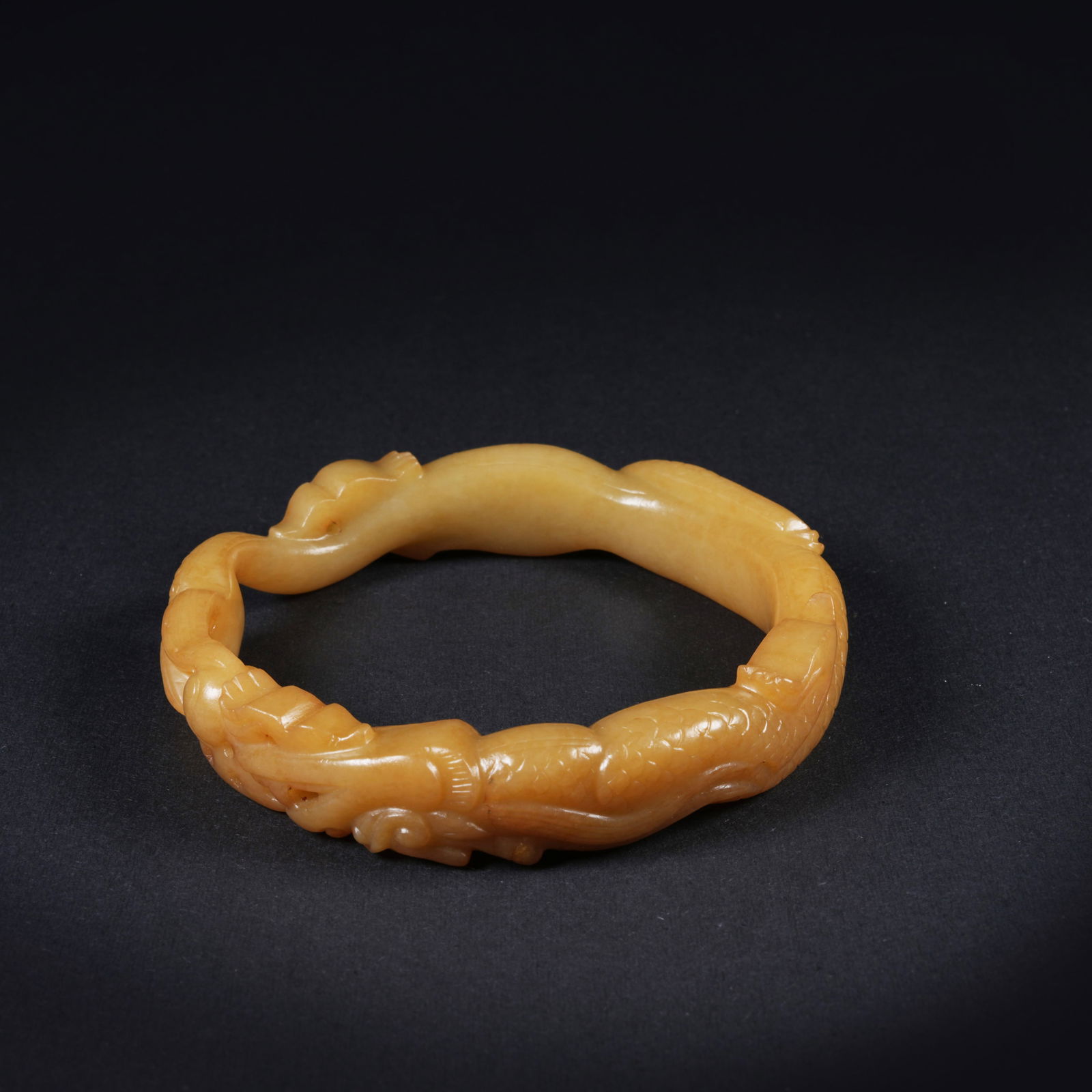 A ANCIENT JADE BRACELET WITH DRAGON MOTIF: Ancient jade bracelet with dragon motif