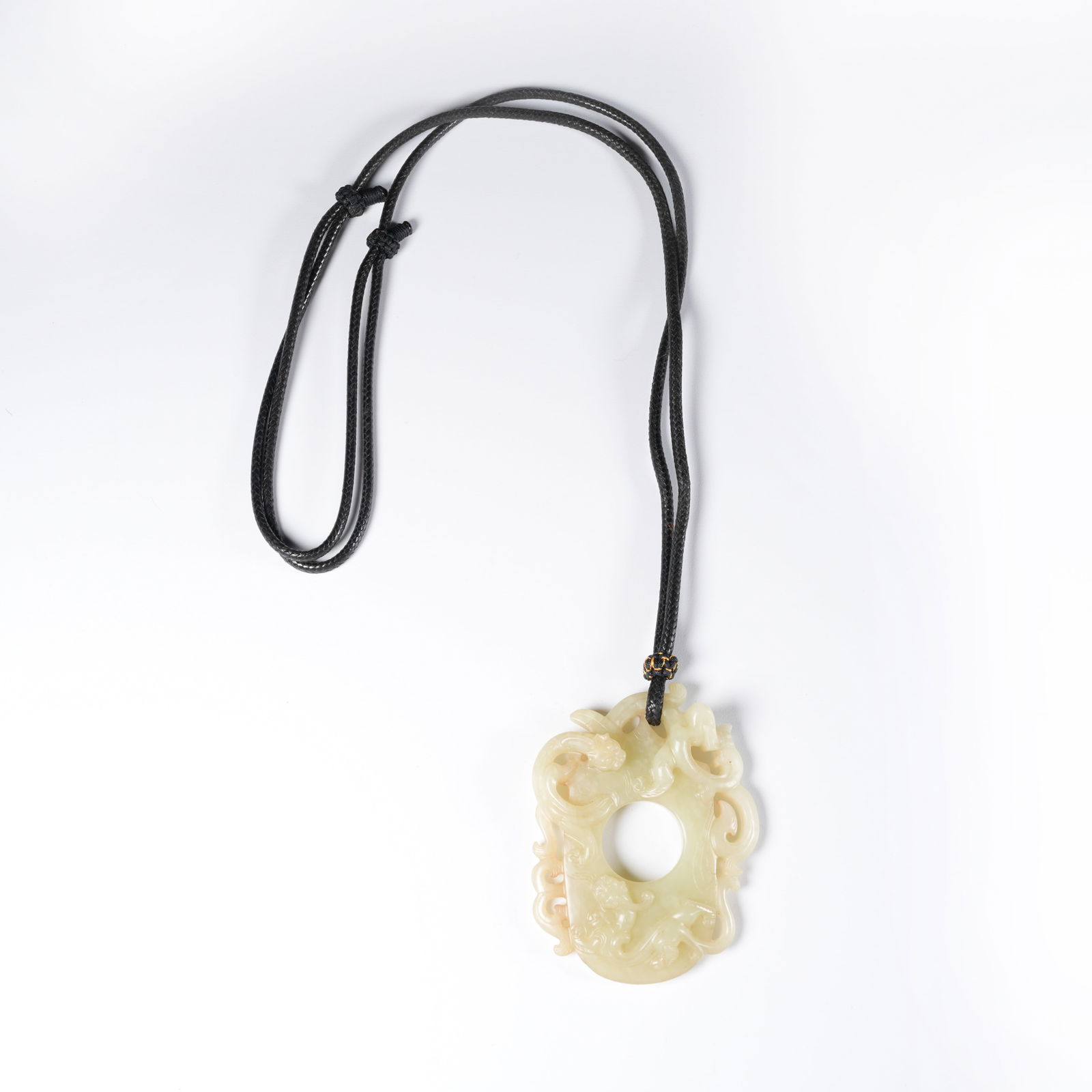 A ANCIENT JADE CHICKEN-HEART PENDANT WITH DRAGON MOTIF: Ancient jade chicken-heart pendant with dragon motif