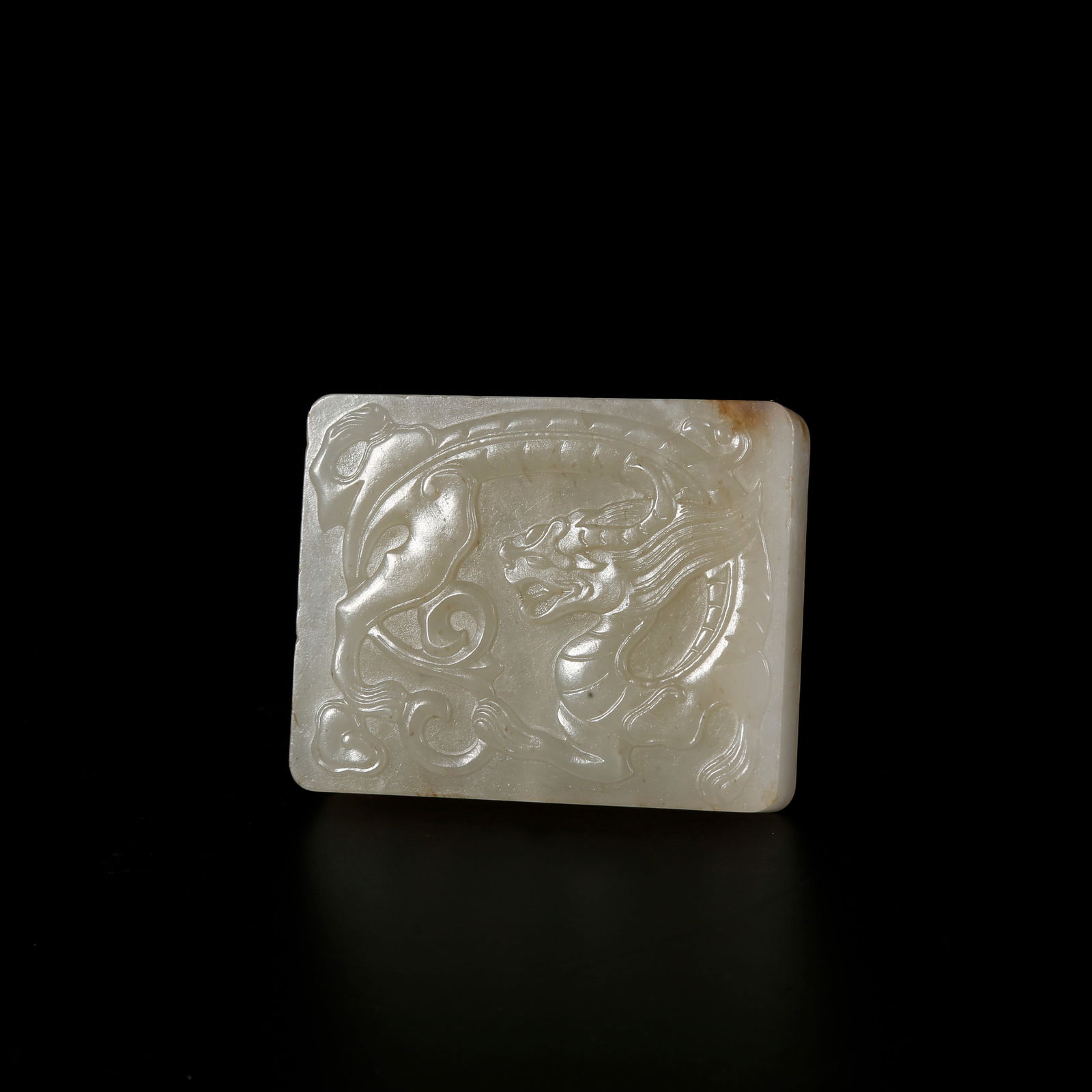 A HETIAN JADE PENDANT WITH DRAGON MOTIF: Hetian jade pendant with dragon motif