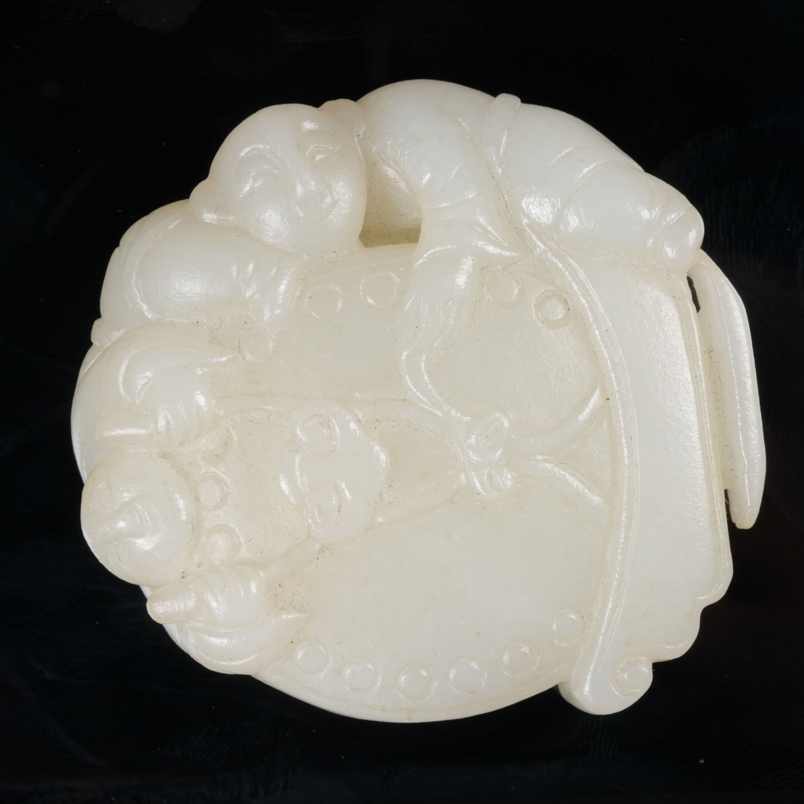 A HETIAN JADE ORNAMENT DEPICTING INFANTS AT PLAY: Hetian jade ornament depicting infants at play