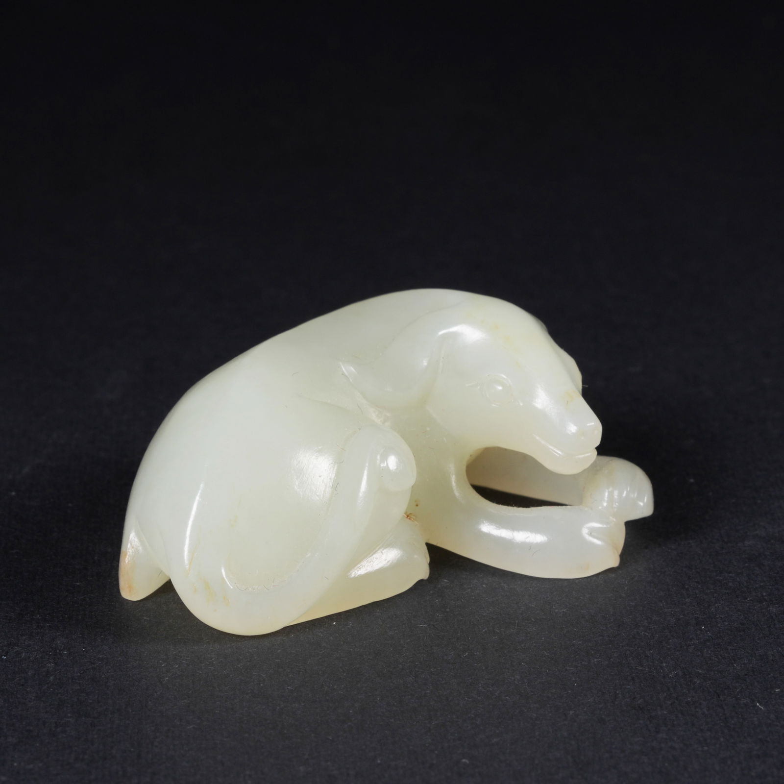 A HETIAN JADE MYTHICAL-BEAST PENDANT: Hetian jade mythical-beast pendant